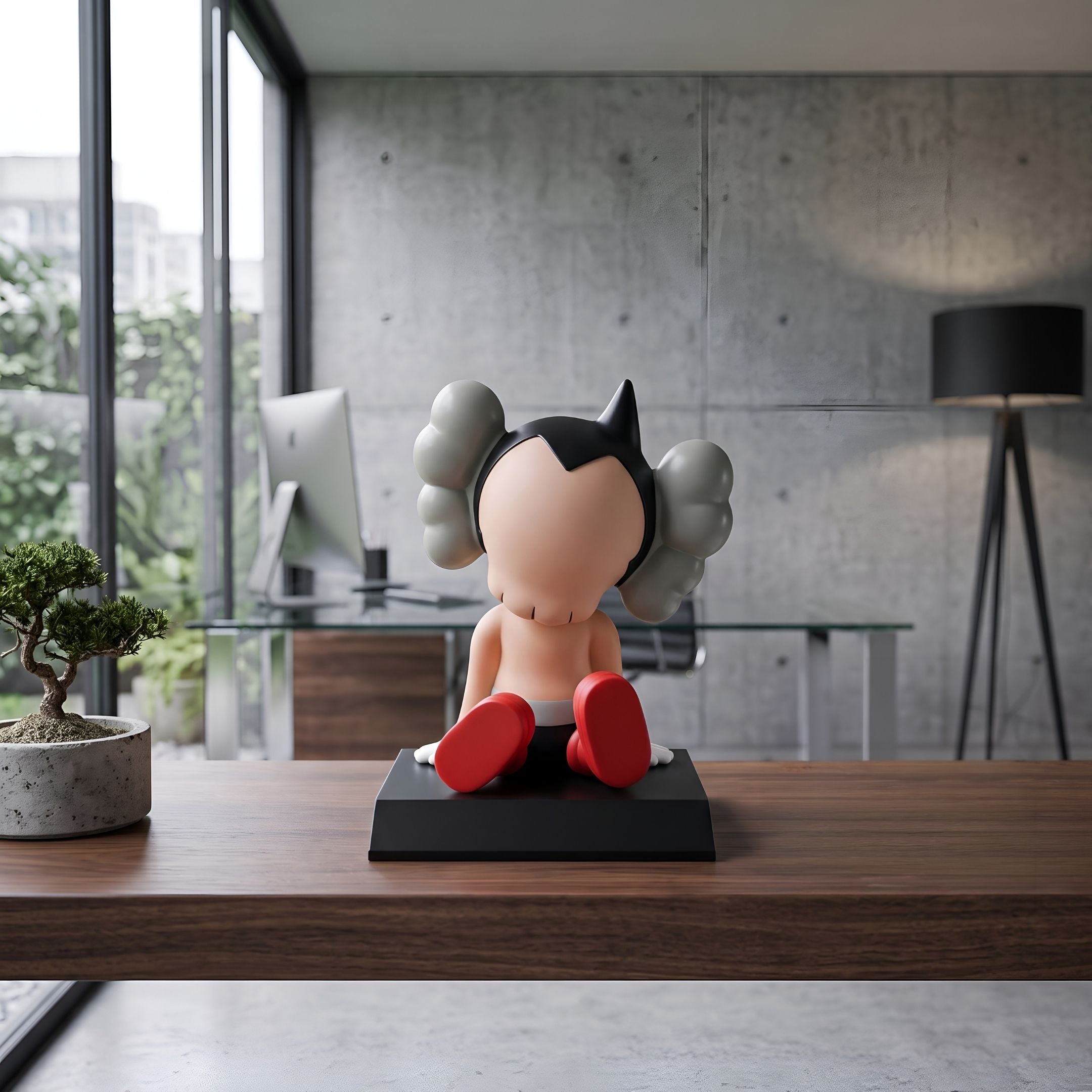 Fiery Red Iconify Bobblehead Cosmic Boy Figure, 10cm vinyl piece on black base, shown rear-view on a desk in an office setting with a monitor and floor lamp.