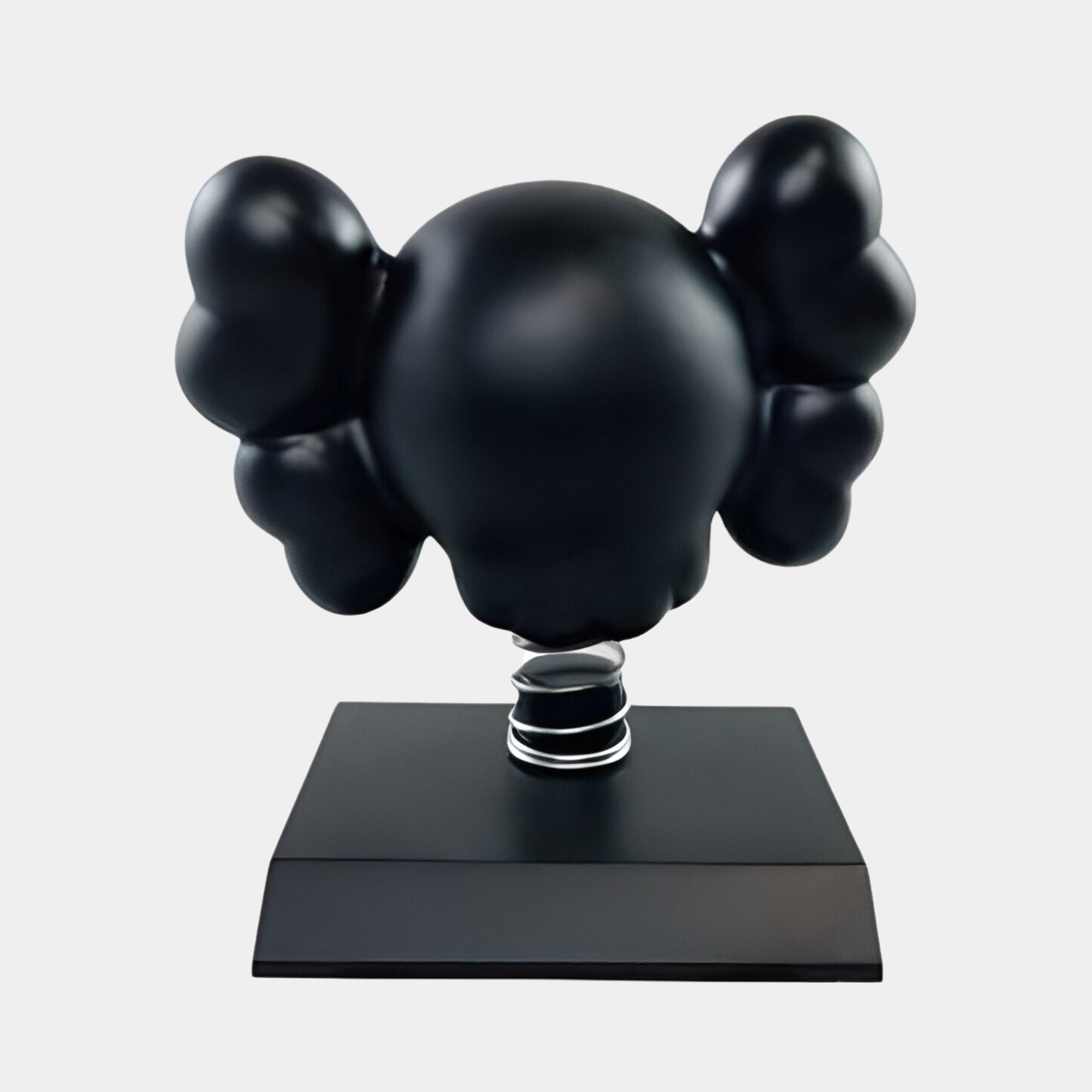 The Midnight Black II Iconify Bobblehead Figure by Giant Sculptures features a rounded head and large, puffy ears like a mouse. This contemporary decor piece is mounted on a square base against a plain light gray background, resembling an elegant bobblehead.