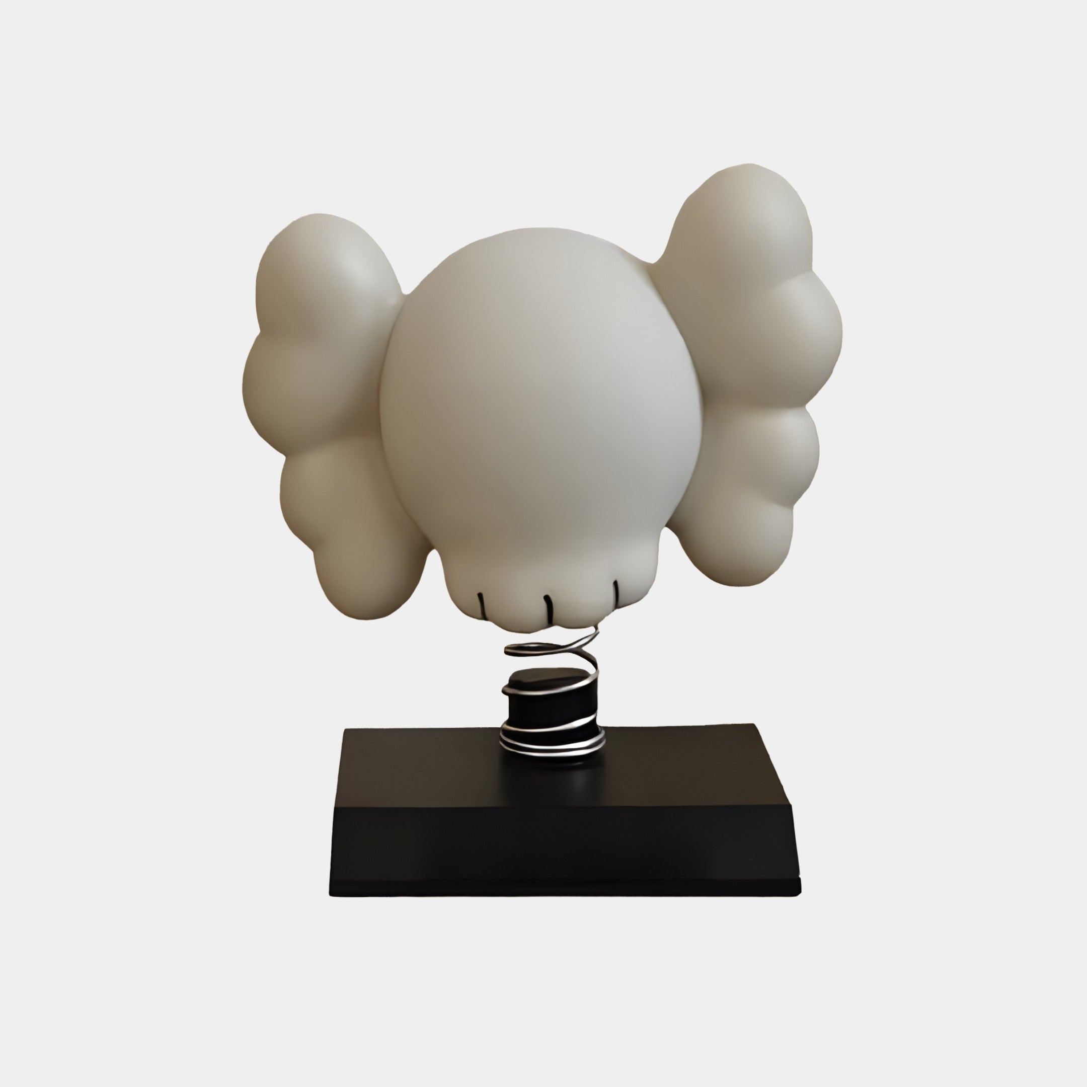 The Dove Grey II Iconify Bobblehead Figure by Giant Sculptures is a 10cm modern collectible with a cartoonish white head and large, symmetrical ear-like shapes, elegantly mounted on a black base with a spiraled metal stand against a plain white background.