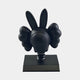 The Obsidian Black Iconify Bobblehead Rabbit Figure - 10cm by Giant Sculptures showcases a sleek character with long bunny ears and cloud-like gloves on a pedestal. Its smooth finish pops against a plain white background, creating an eye-catching element of modern art decor.