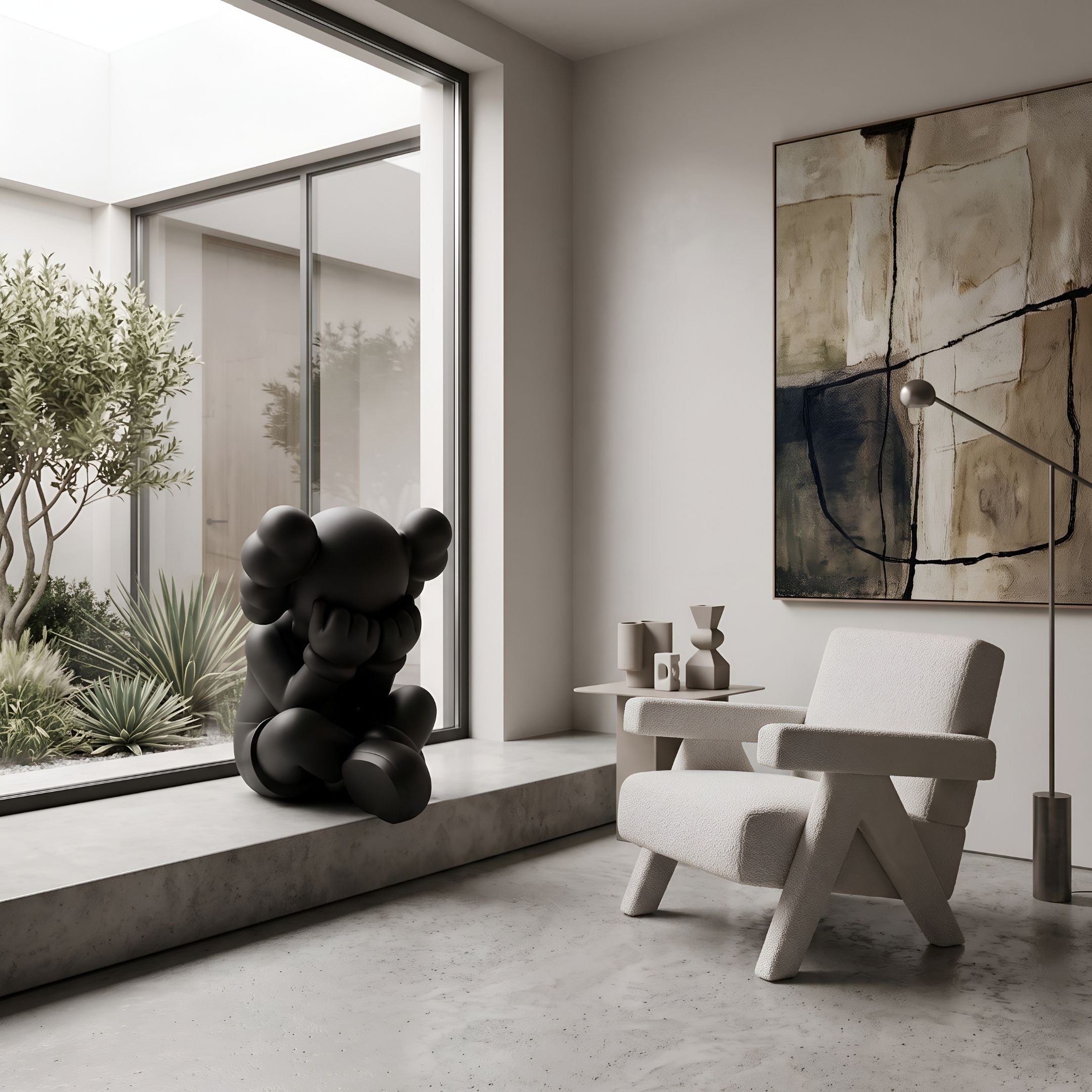 Obsidian Black Iconify Sorrow Sculpture, 92cm, seated figure with hands covering face, shown on a concrete window ledge beside a boucle armchair and abstract wall art.