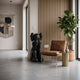 Midnight Black Iconify Melancholy Sitting Sculpture, 110cm, seated figure covering its face, resin black finish, shown beside a leather chair in a modern living room.