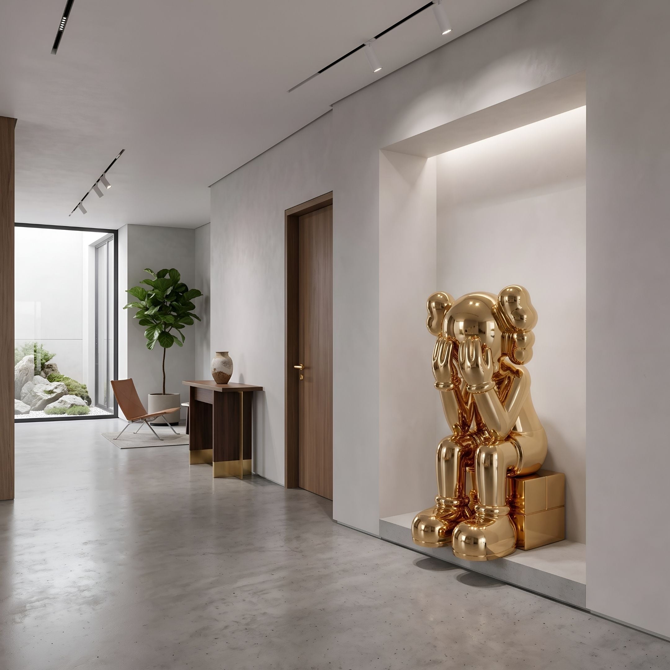 Antique Gold Iconify Melancholy Sitting Sculpture, 110cm, seated with hands covering face in a wall niche of a modern hallway near a wood console and plant.