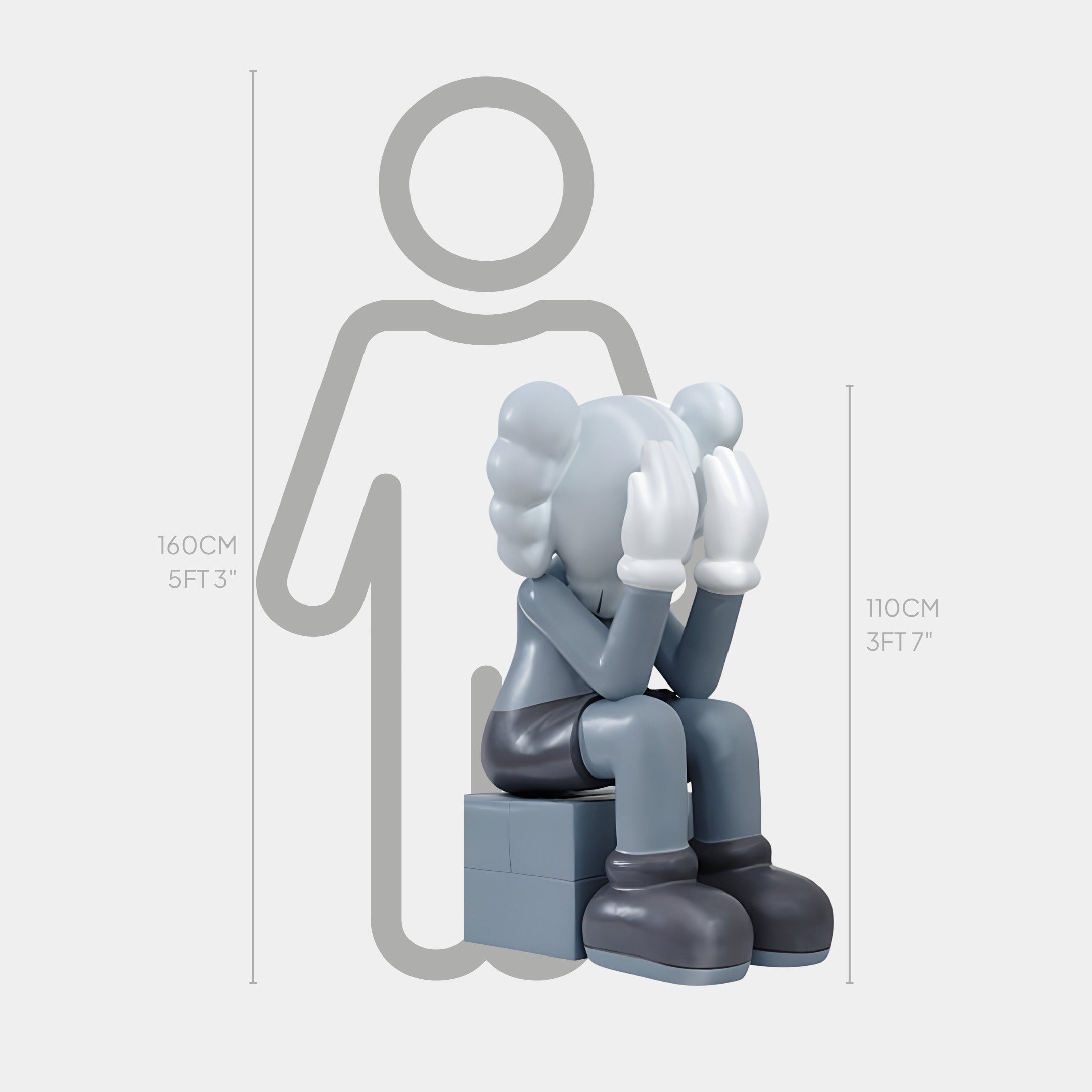 The Slate Grey Iconify Melancholy Sitting Sculpture by Giant Sculptures features a 110 cm stylized character with gloved hands covering its face while seated on a block, embodying melancholy. It sits before a 160 cm person outline.