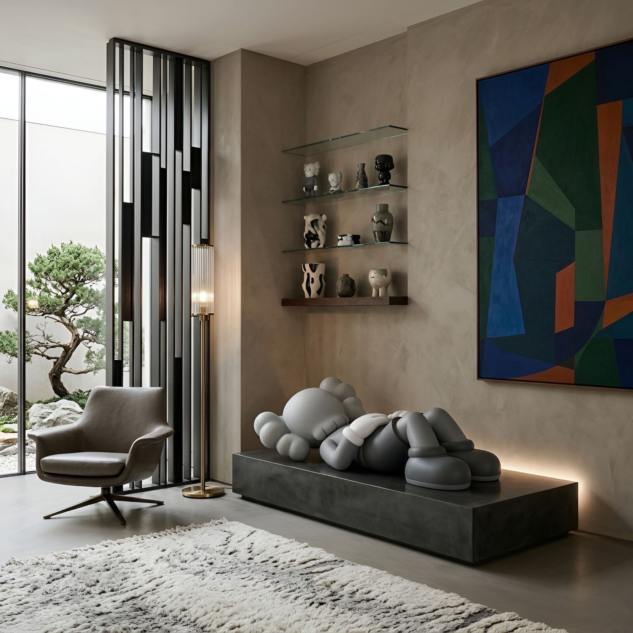 Soft Grey Iconify Peace Sculpture, 110cm, reclining figure on a dark platform in a living room with shelving, armchair, and abstract wall art.