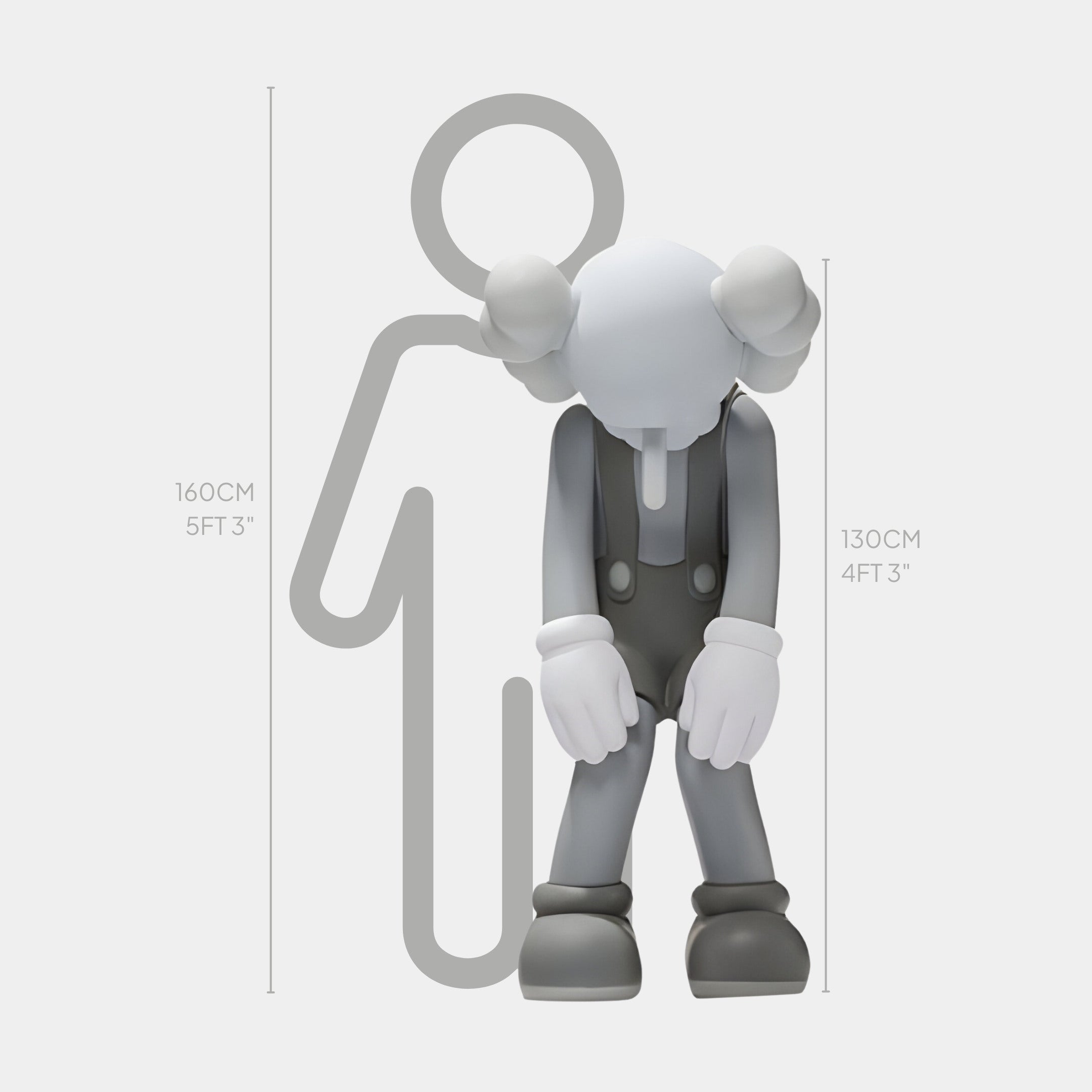 The Slate Grey Iconify Burden Sculpture by Giant Sculptures portrays a gray cartoon character with large gloves and pants, slumped forward. At 130 cm, it contrasts with a simplified human figure of 160 cm to symbolize modern introspection and resilience.