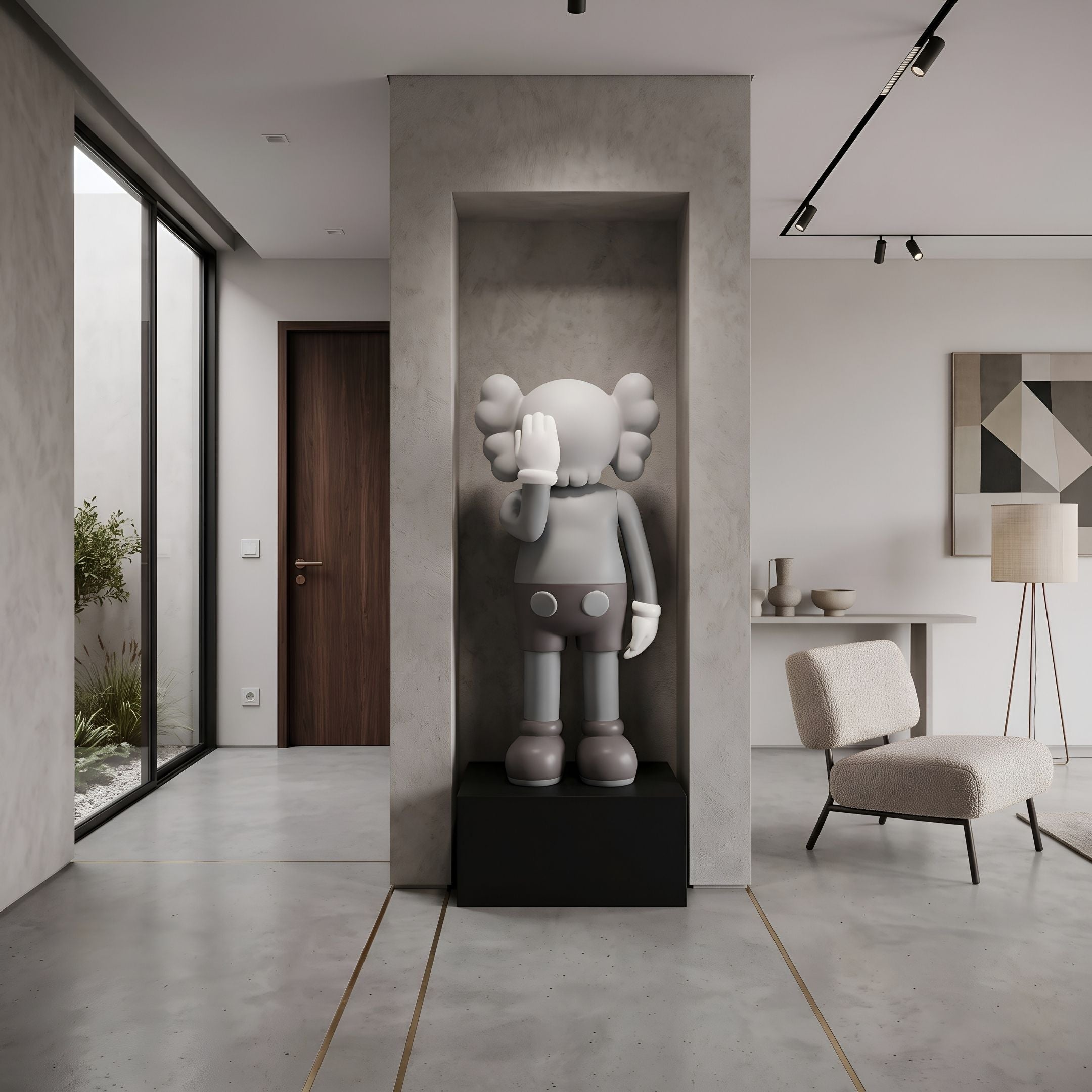 Soft Grey Iconify V Dance Sculpture, 130cm, displayed in a wall niche on a black plinth in a modern living room beside a bouclé armchair.