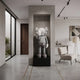 Soft Grey Iconify V Dance Sculpture, 130cm, displayed in a wall niche on a black plinth in a modern living room beside a bouclé armchair.