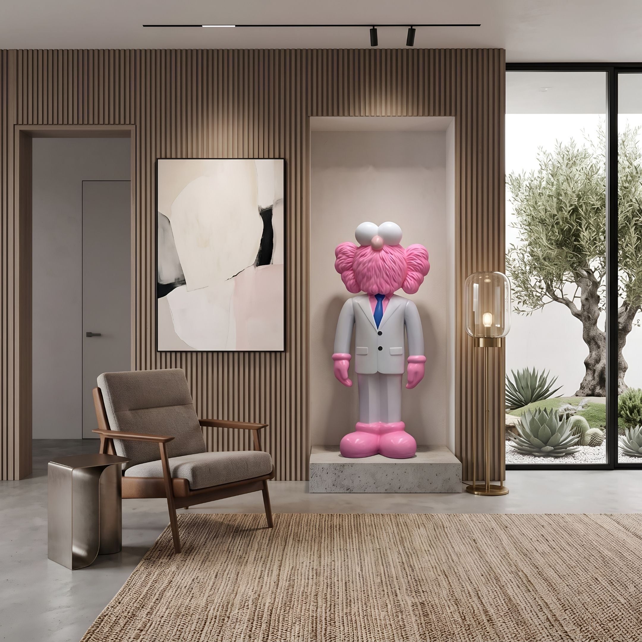White Suit Iconify CEO Sculpture, 130cm, pink figure in white suit and blue tie on stone plinth in wall niche, beside chair and abstract art.