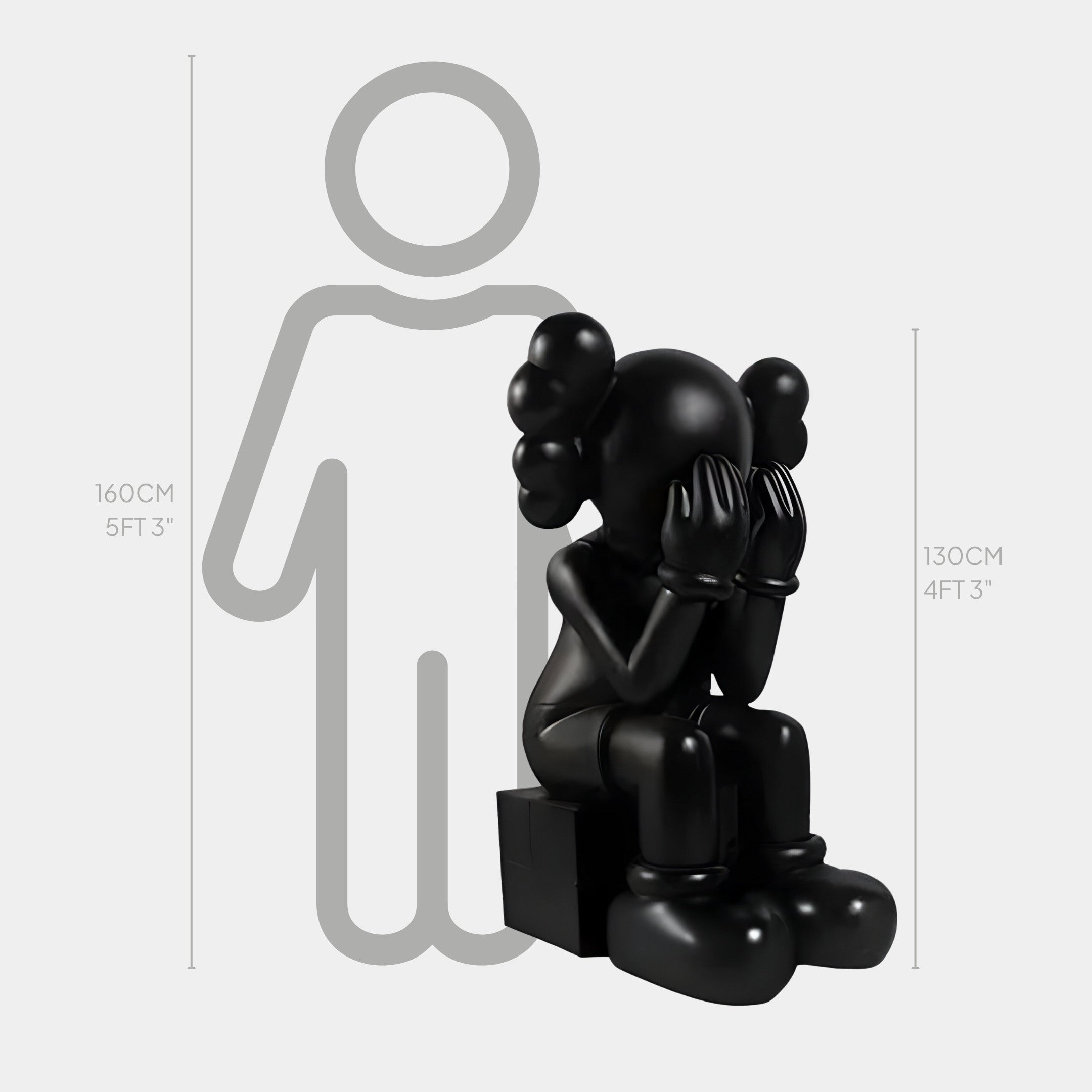 The Midnight Black Iconify Melancholy Sitting Sculpture by Giant Sculptures stands at 130 cm and features a seated character with hands over its face, round ears, and gloves. This monochrome piece contrasts with an outlined figure reaching 160 cm.