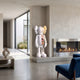 Cloud White Iconify Anatomy Sculpture, 130cm, standing figure with exposed internal anatomy detail, displayed beside a fireplace in a modern living room.