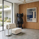 Midnight Black Iconify Standing Sculpture, 130cm, in a living room beside a woven blue wall art and cream boucle chair.