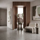 Hazelnut Brown Iconify Standing Sculpture, 130cm, by Giant Sculptures, shown in a hallway nook near a wood-paneled window, beige armchair, and abstract wall art.