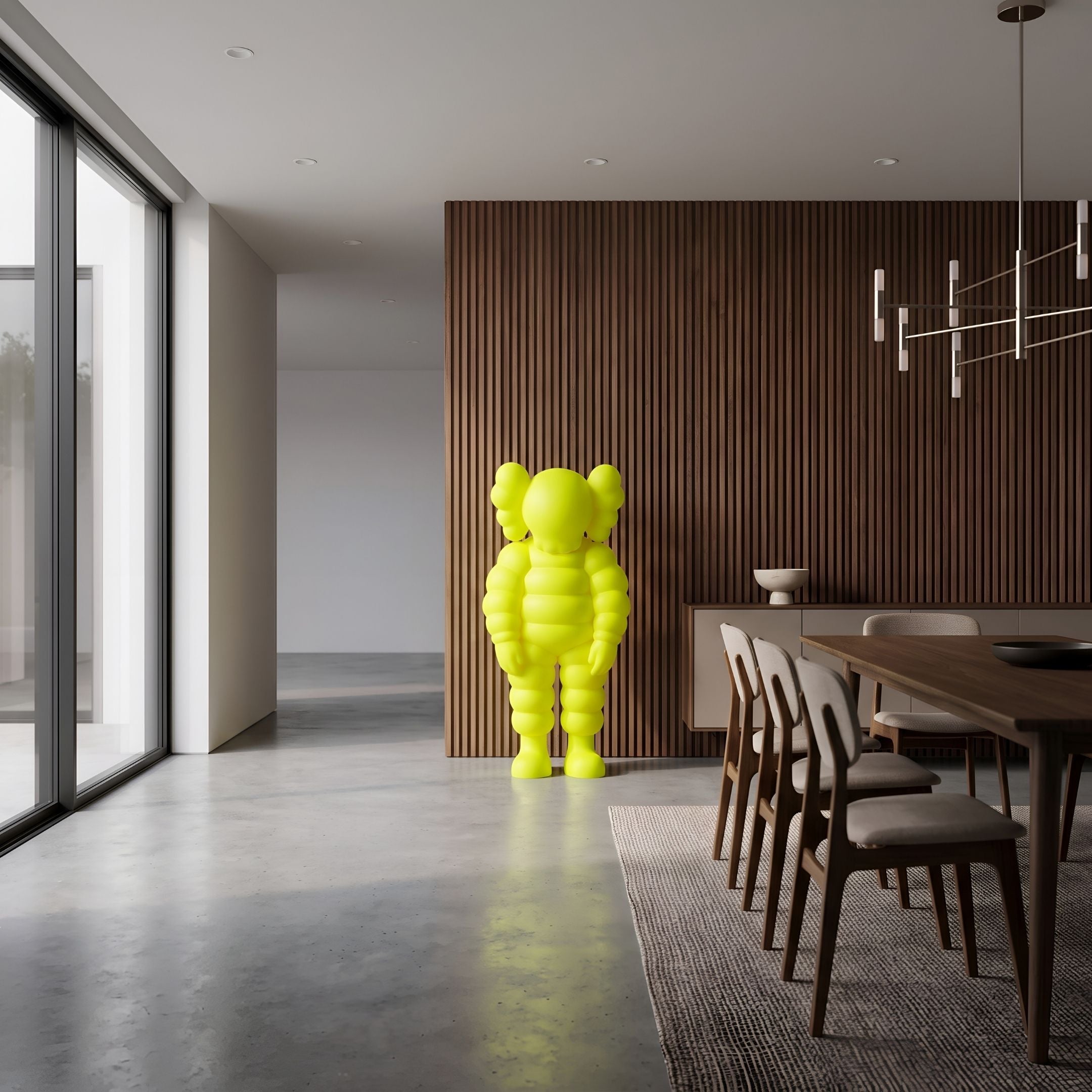 Citrus Yellow Iconify Rollo Sculpture, 130cm, standing in a dining area with wood slat wall, dark table, and upholstered chairs.