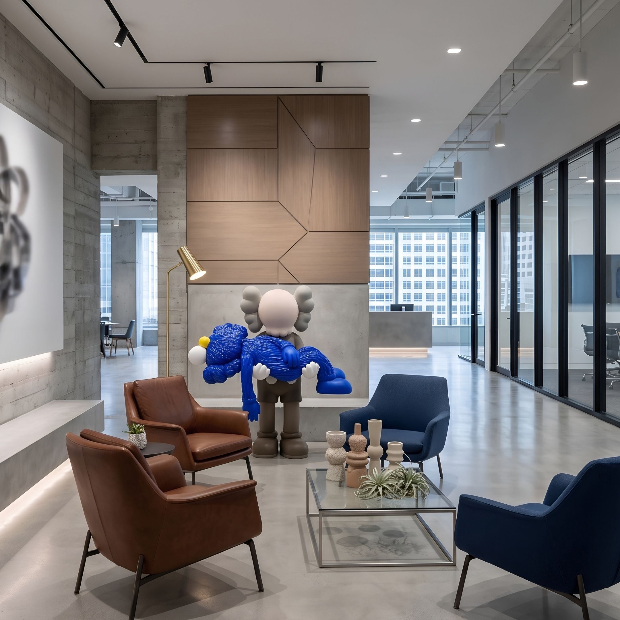 Royal Blue Iconify Rescuing Furry Sculpture, 135cm, resin figure bending over a blue furry character, displayed in a lounge with leather chairs and a coffee table.