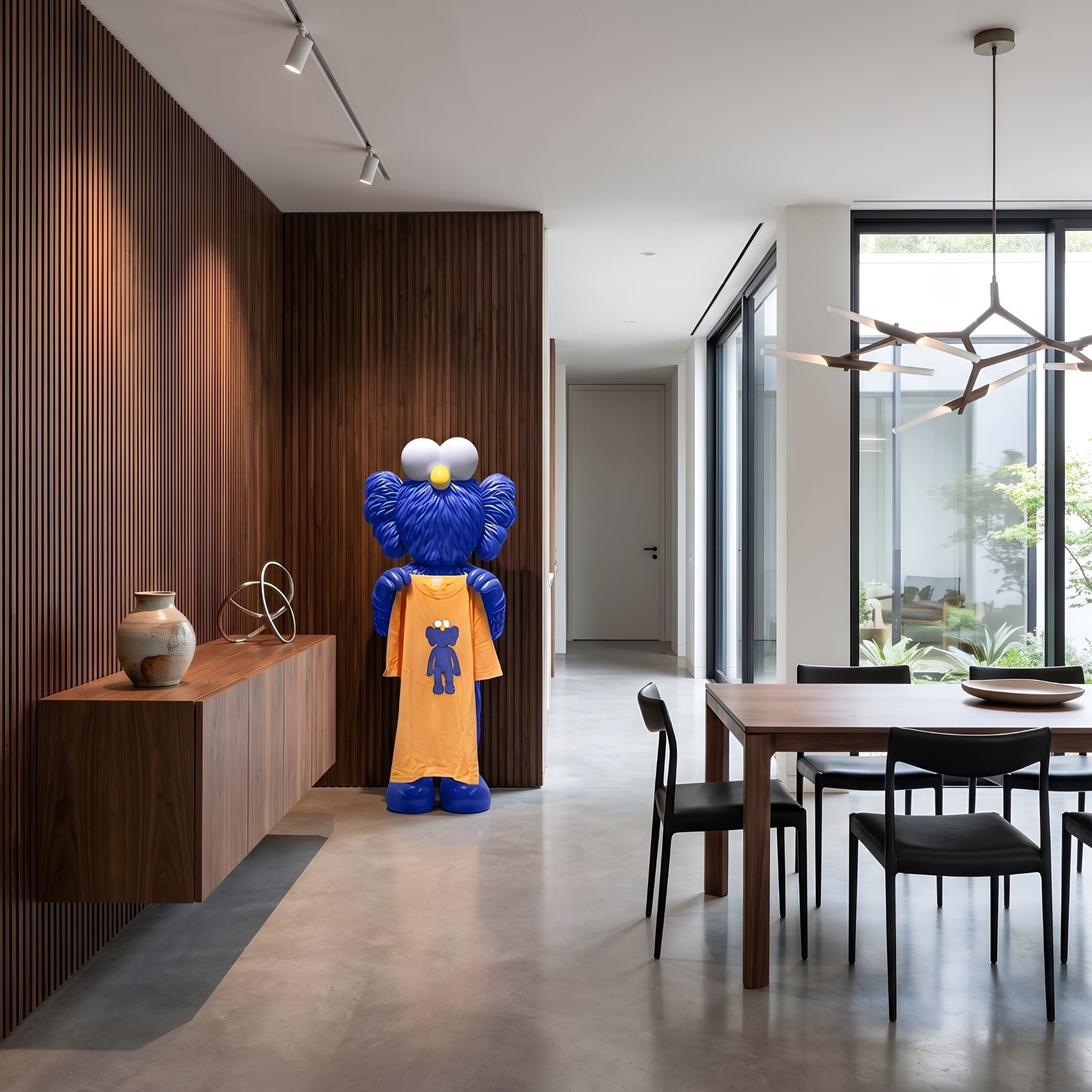 Deep Blue Iconify Furry T-Shirt Sculpture, 135cm, blue furry finish with yellow t-shirt, shown beside a wood-paneled wall in a dining area.