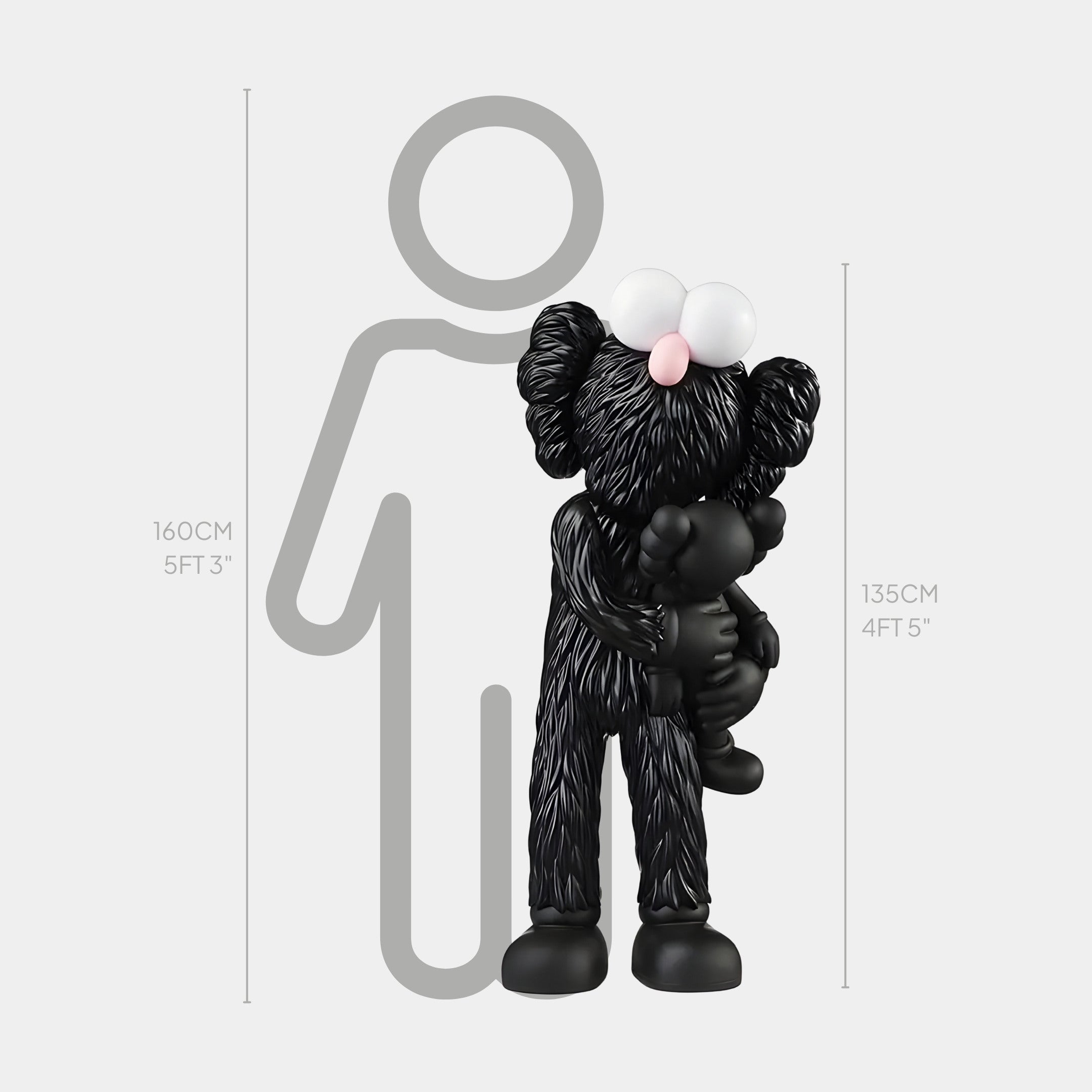 The Obsidian Black Iconify Loving Furry Sculpture by Giant Sculptures features a black cartoon character with big white eyes holding a small figure, exuding emotional depth beside a 160 cm (5ft 3in) grey outline of a person. The sculpture itself measures 135 cm (4ft 5in).