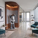 Slate Grey Iconify Cosmic Boy Sculpture, 140cm, in a wood-paneled office alcove, shown in a shy pose with hand covering face, near teal armchairs and glass meeting rooms.