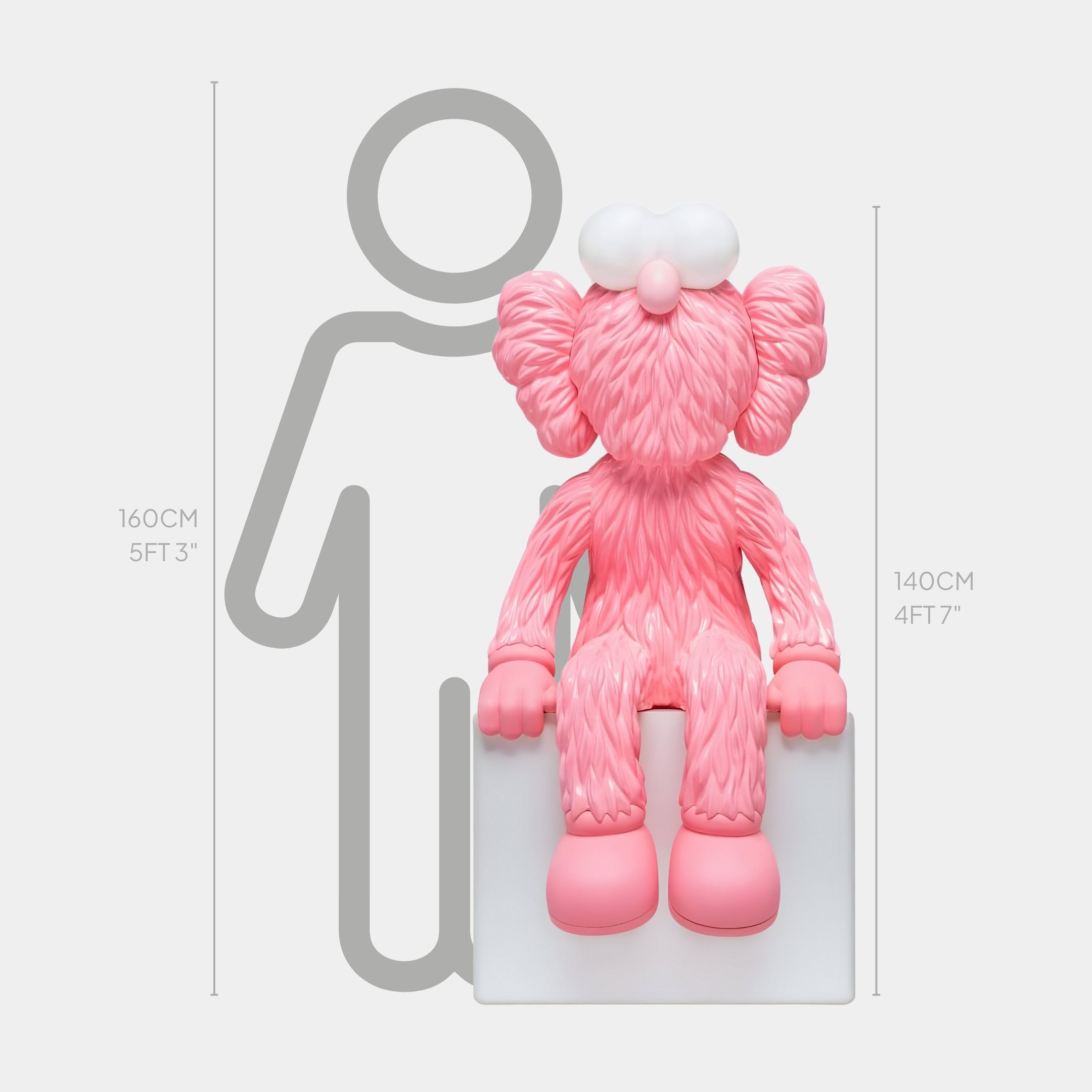 The Petal Pink Iconify Furry Sitting Sculpture by Giant Sculptures perches on a white block, with exaggerated features. A gray outline of a person marks 160 cm (5 ft 3 in) and 140 cm (4 ft 7 in). Against a plain white backdrop, it makes a striking contemporary art statement.