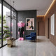 Black Suit Iconify CEO Sculpture, 147cm, standing in a modern hallway with pink fur-textured head and hands, black suit, near a blue armchair and abstract wall art.