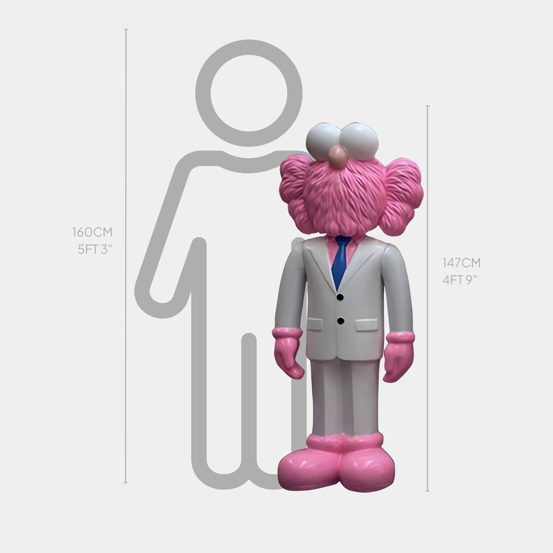 Beside a scale outline, the Giant Sculptures White Suit Iconify CEO Sculpture—a pink and white cartoon figure in a sleek white suit and blue tie—stands at 147 cm (4 ft 9 in), compared to the 160 cm (5 ft 3 in) outline.