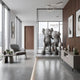 Slate Grey Iconify Friendship Sculpture, 150cm, three cartoonish figures with one arm around the others, shown in a modern lounge near a grey armchair and floor-to-ceiling windows.