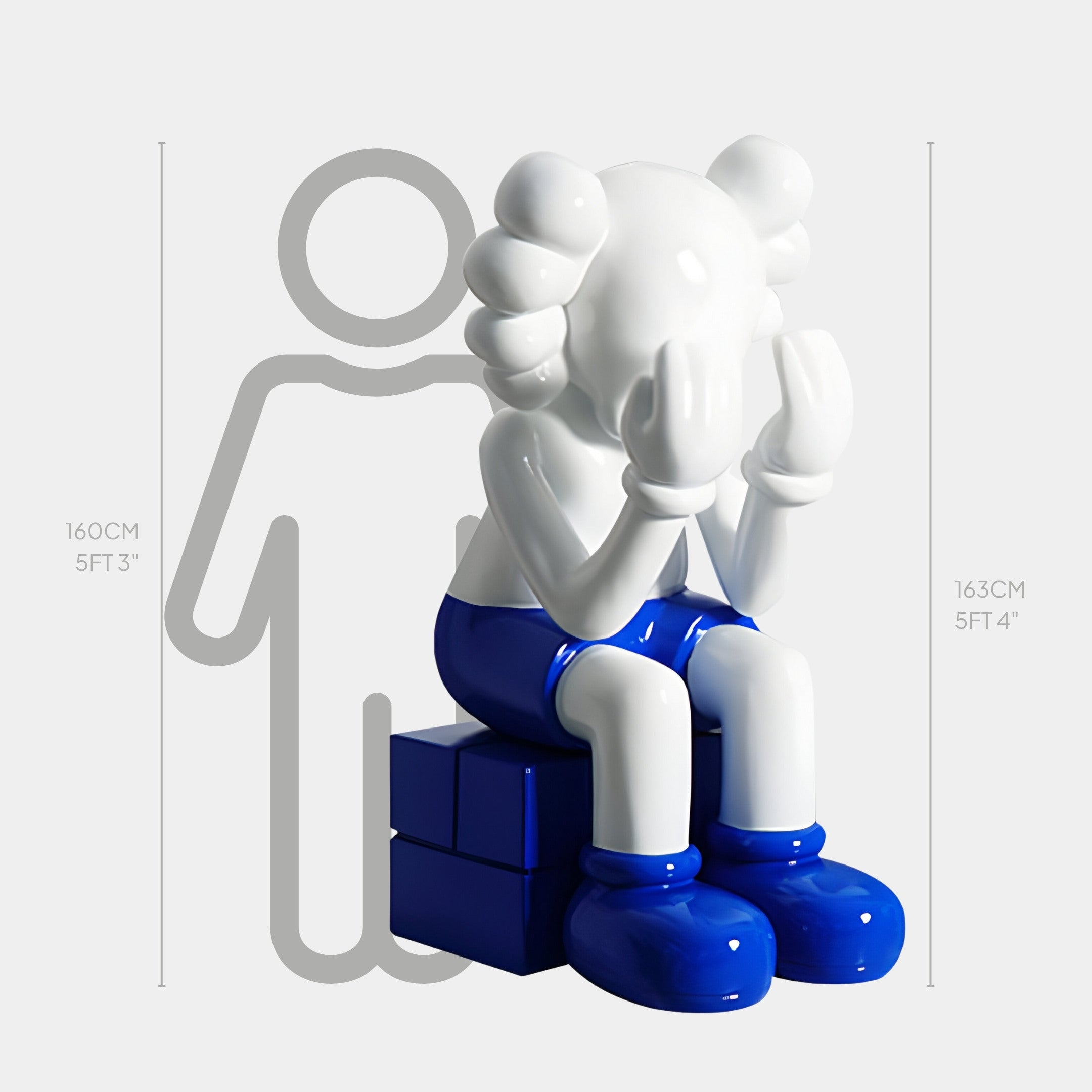 The White & Blue Iconify Melancholy Sitting Sculpture, by Giant Sculptures, is a 163 cm high cartoon-style piece made from high-quality resin. The seated figure hides its face in melancholy, wearing bright blue shorts and shoes—ideal for contemporary interiors.