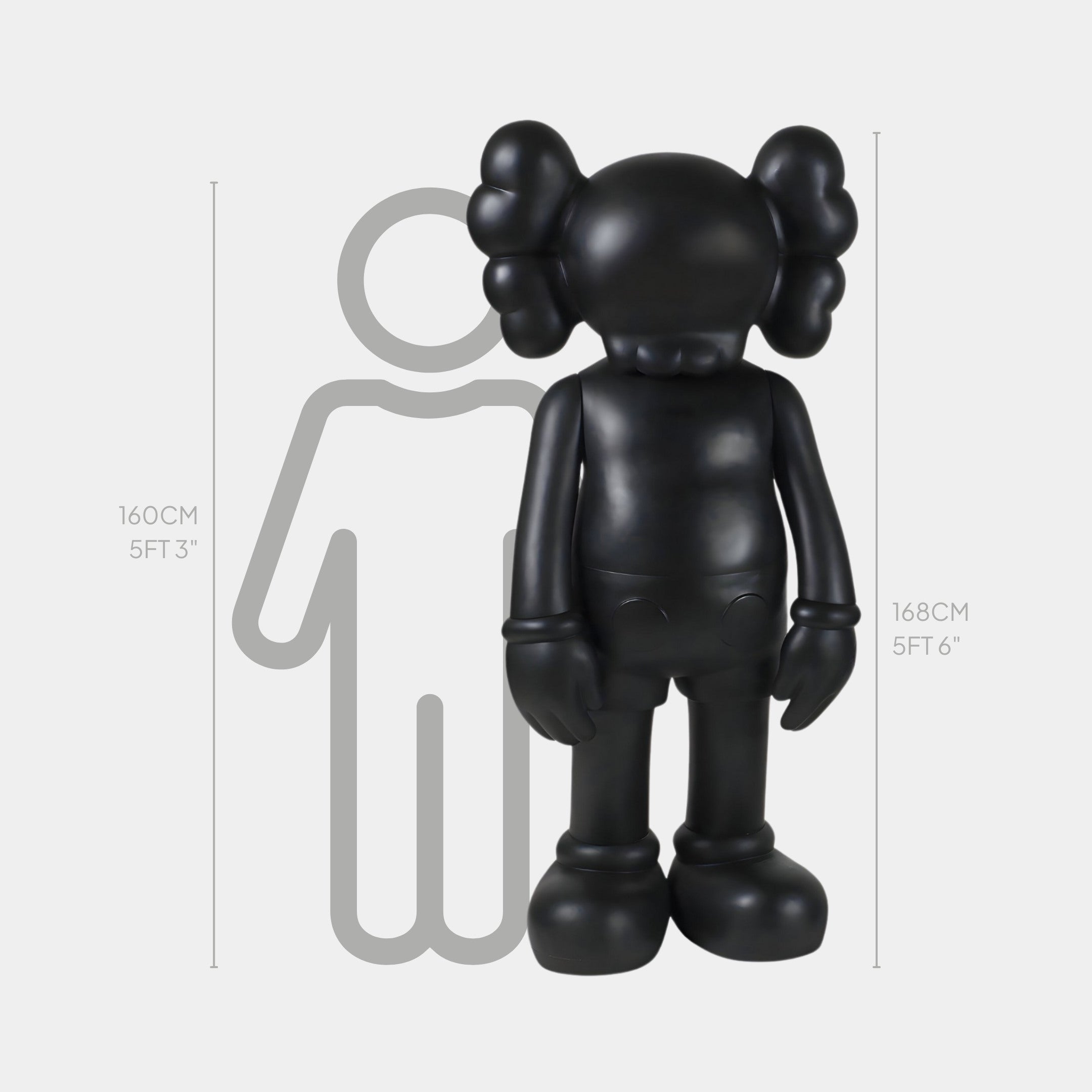 The Midnight Black Iconify Standing Sculpture by Giant Sculptures, at 168 cm (5 ft 6 in), features a black cartoon-like figure with X eyes, large round feet, gloved hands, and balloon-like head protrusions against a 160 cm (5 ft 3 in) outline, adding modern elegance to contemporary interiors.