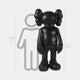 The Midnight Black Iconify Standing Sculpture by Giant Sculptures, at 168 cm (5 ft 6 in), features a black cartoon-like figure with X eyes, large round feet, gloved hands, and balloon-like head protrusions against a 160 cm (5 ft 3 in) outline, adding modern elegance to contemporary interiors.