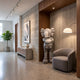 Soft Grey Iconify III Dance Sculpture, 170cm, standing figure with gloved hands covering its face, shown in a wood-paneled hallway beside an armchair and floor lamp.
