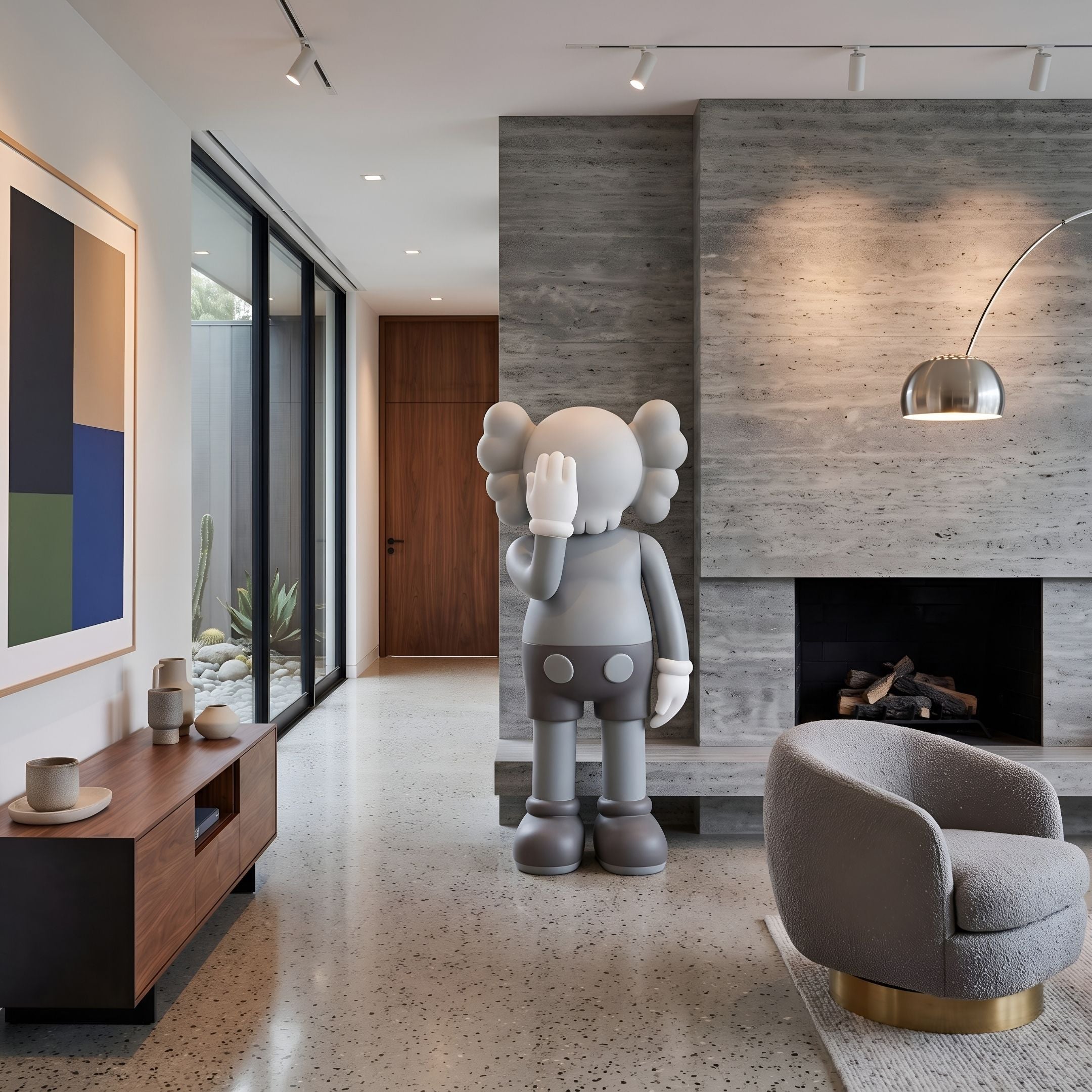 Soft Grey Iconify V Dance Sculpture, 170cm, standing in a modern living room beside a stone fireplace, walnut console, and grey armchair.