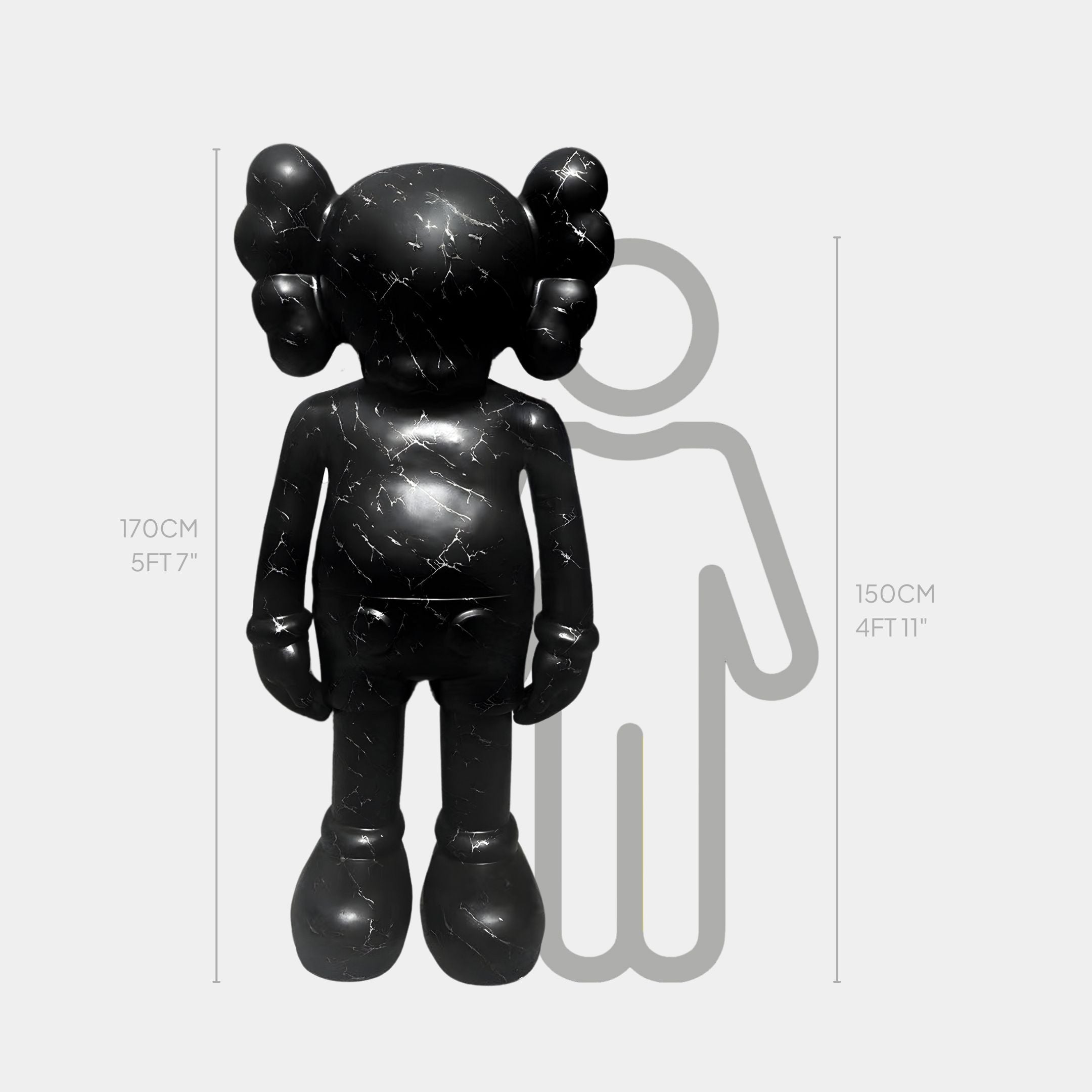 The Giant Sculptures Black Stone Iconify Standing Sculpture - 170cm, with round features and crossed-out eyes, stands before a simple person outline measuring 150 cm (4 ft 11 in) tall.