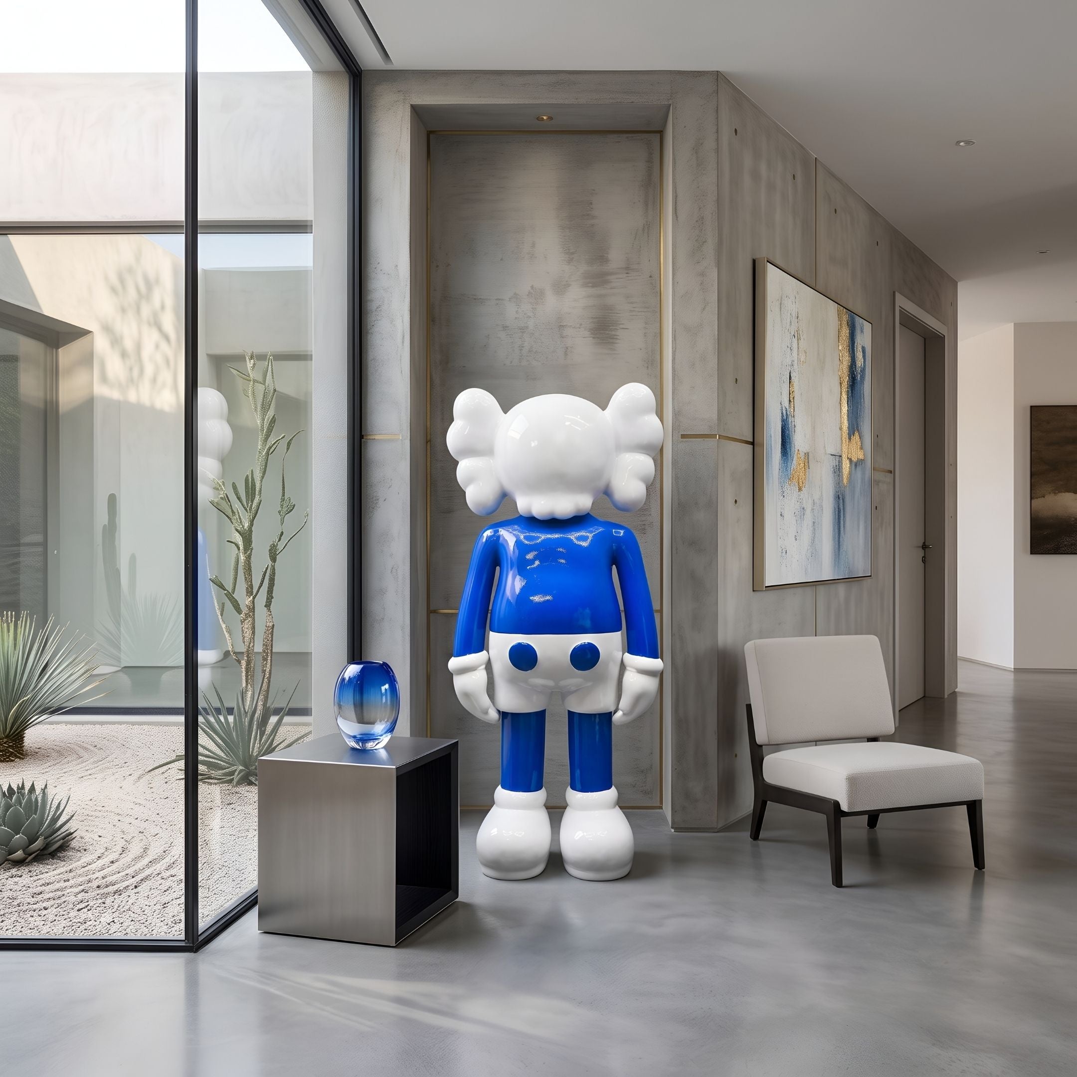 Deep Blue Iconify Standing Sculpture, 170cm, in blue and white resin, displayed in a modern hallway beside a grey chair and glass courtyard view.