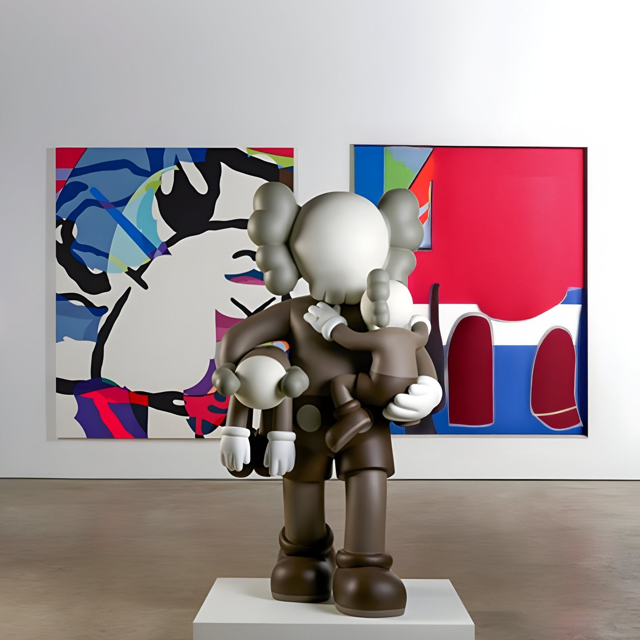 A 200cm Hazelnut Brown Iconify Family Sculpture by Giant Sculptures graces the gallery, cradling a smaller figure. Two vibrant abstract artworks decorate the walls, showcasing a contemporary style on a wooden floor in this modern art exhibition space.