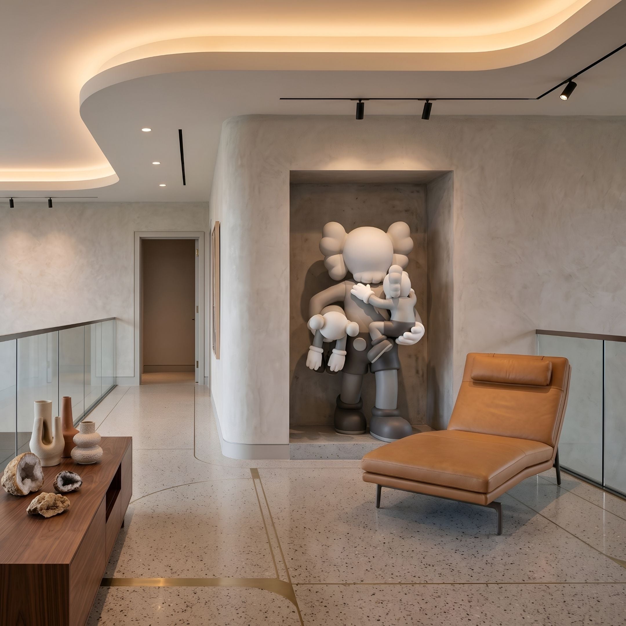 Soft Grey Iconify Family Sculpture (180cm) by Giant Sculptures, displayed in a wall niche with a leather chaise nearby in a modern hallway setting.