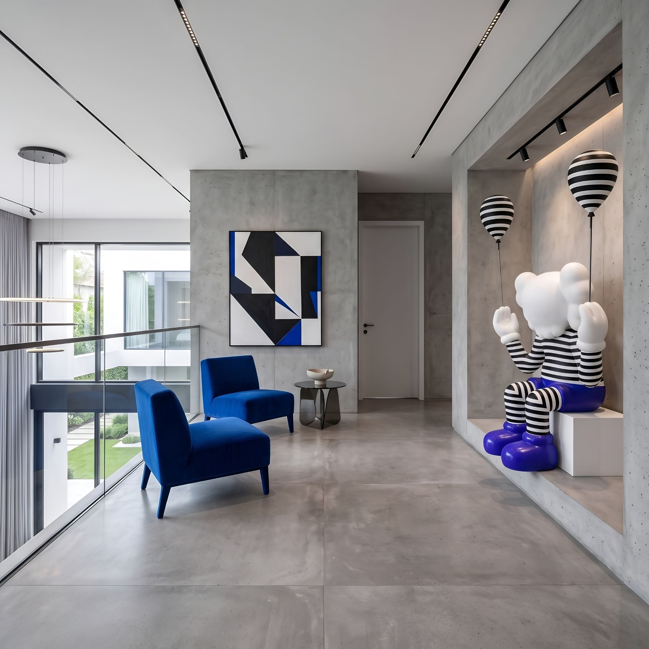 Deep Blue Iconify Mime Sitting Sculpture, 195cm, seated on a white block base holding striped balloons, displayed in a modern lounge with blue chairs.