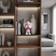 Petal Pink Iconify Peekaboo Figure - 20cm displayed on a wooden shelf beside vases and books, in a living room with a grey sofa.