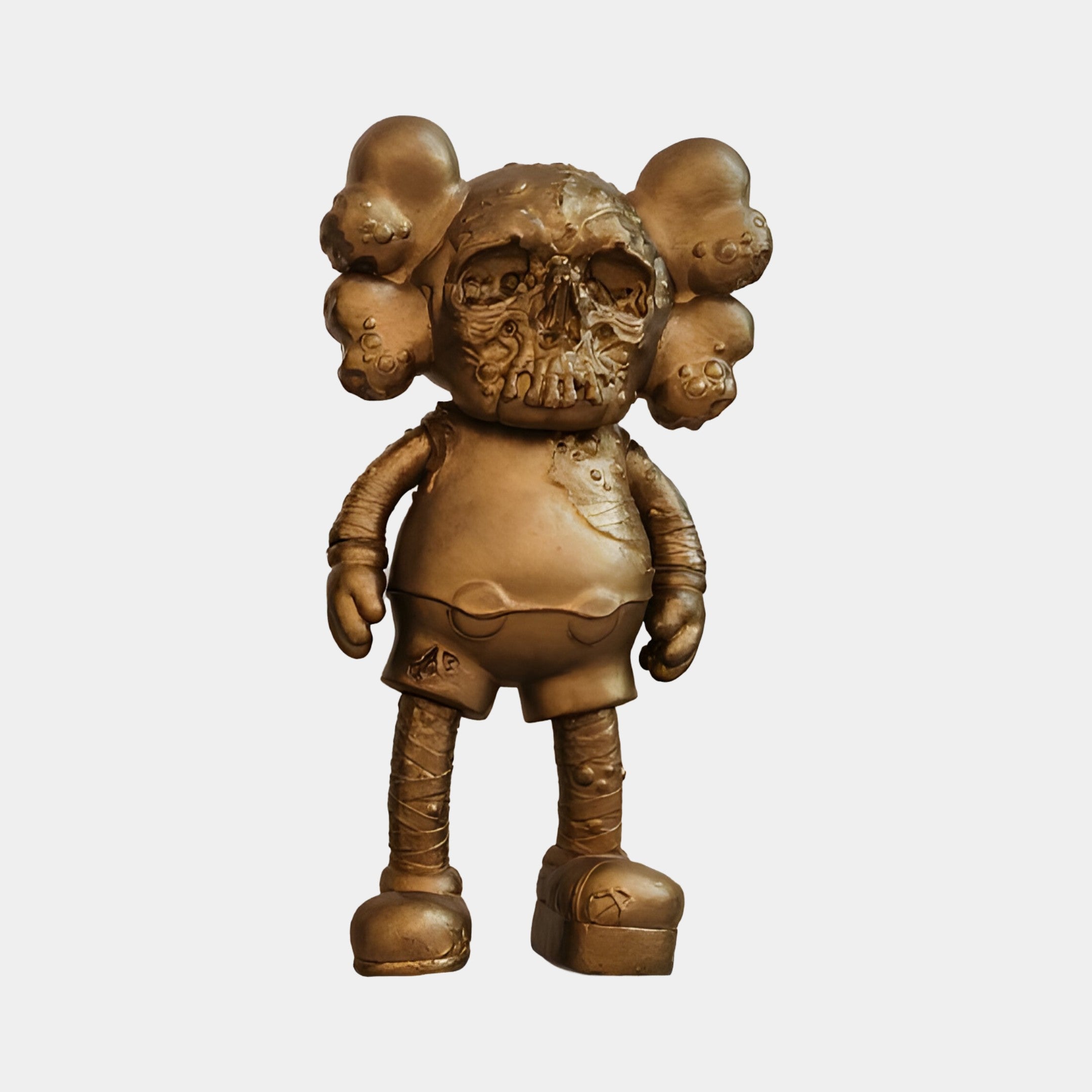 The 20cm Antique Brushed Gold Iconify Scar Figure by Giant Sculptures is a bronze sculpture of a cartoon-like figure with large ears, textured surface, gloves, rounded shoes, and shorts. It features an eroded look for added character.