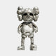 The Weathered Silver Iconify Scar Figure - 20cm by Giant Sculptures is a metallic figurine with a large skull-like head and bulbous ears, blending robotic and organic textures in silver. It features shorts and shoes against a simple background.