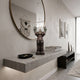 Hazelnut Brown Iconify Silent Cry Figure, 20cm, on a floating console shelf beneath a round mirror in a modern entryway.
