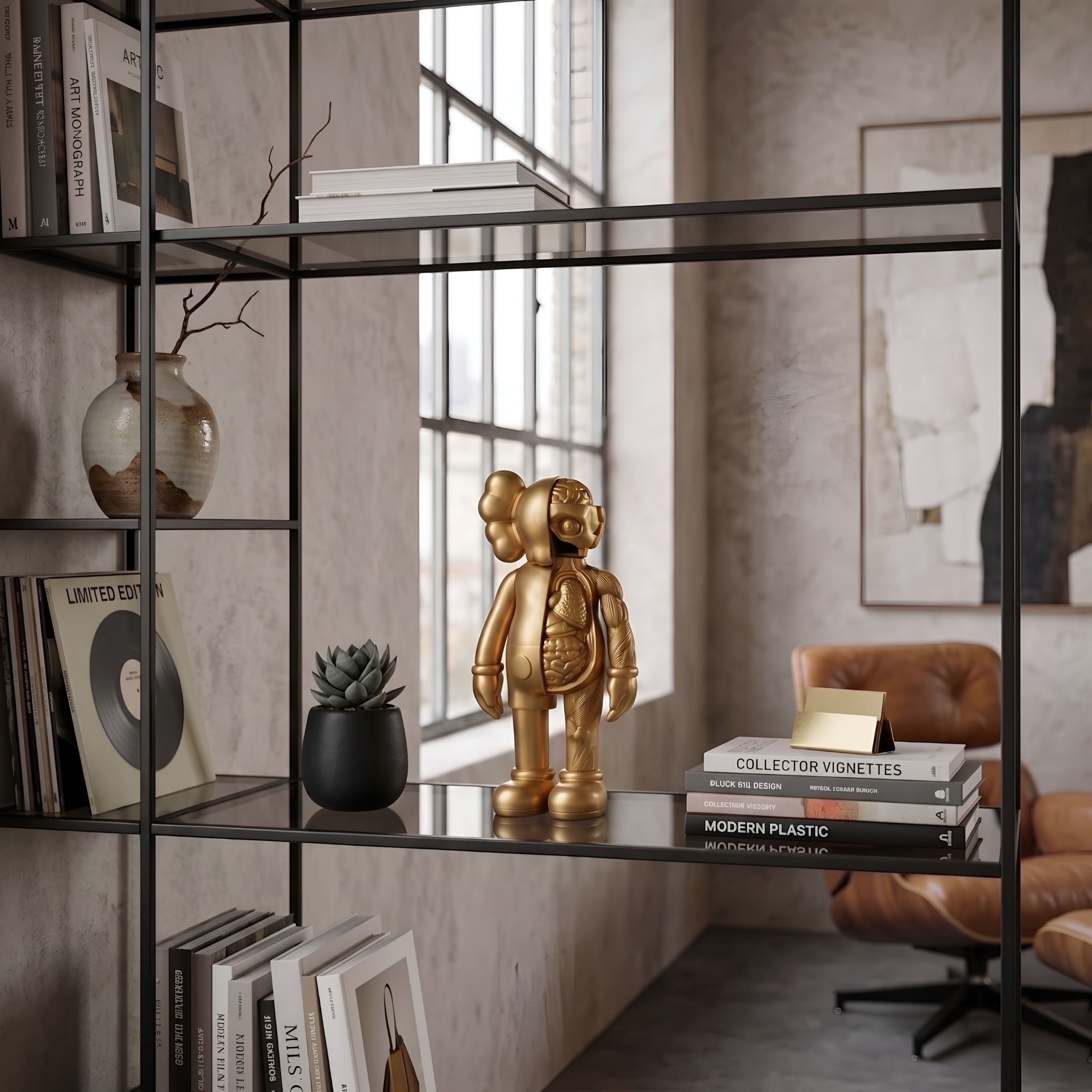 Champagne Satin Gold Iconify Anatomy Figure, 20cm, displayed on a black shelf beside books, a plant, and vase in a living room setting.