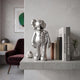 Titanium Slate Iconify Anatomy Figure, 20cm silver bisected-anatomy sculpture displayed on a floating shelf beside books, near a burgundy armchair.