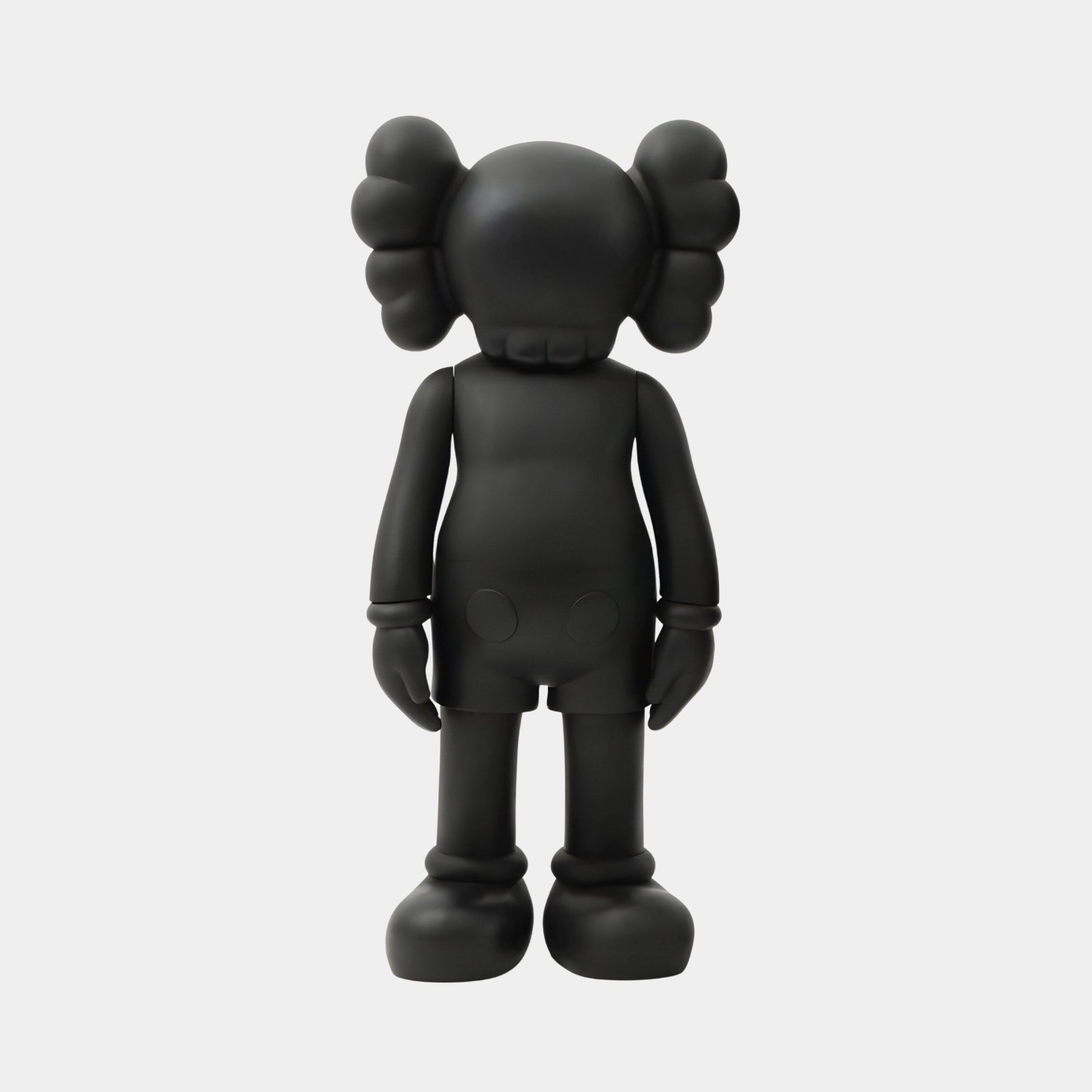 The Midnight Black Iconify Standing Figure by Giant Sculptures is a 20cm contemporary sculpture with a matte finish, cartoonish look, exaggerated features, large round ears, and X-shaped eyes that add a playful touch to any interior décor.