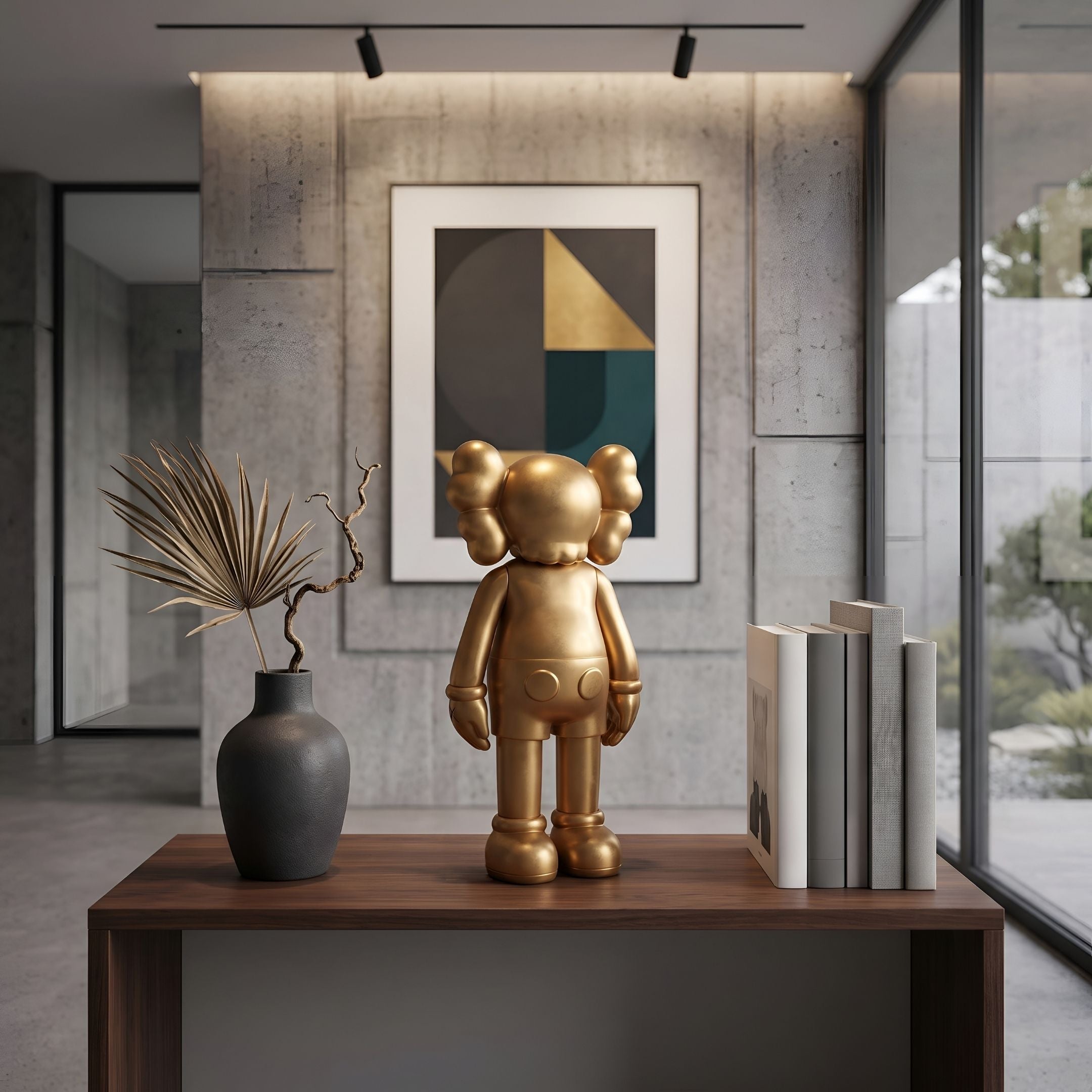 Champagne Satin Gold Iconify Standing Figure (20cm) on a wooden console table beside a dark vase and books, with abstract wall art behind it.