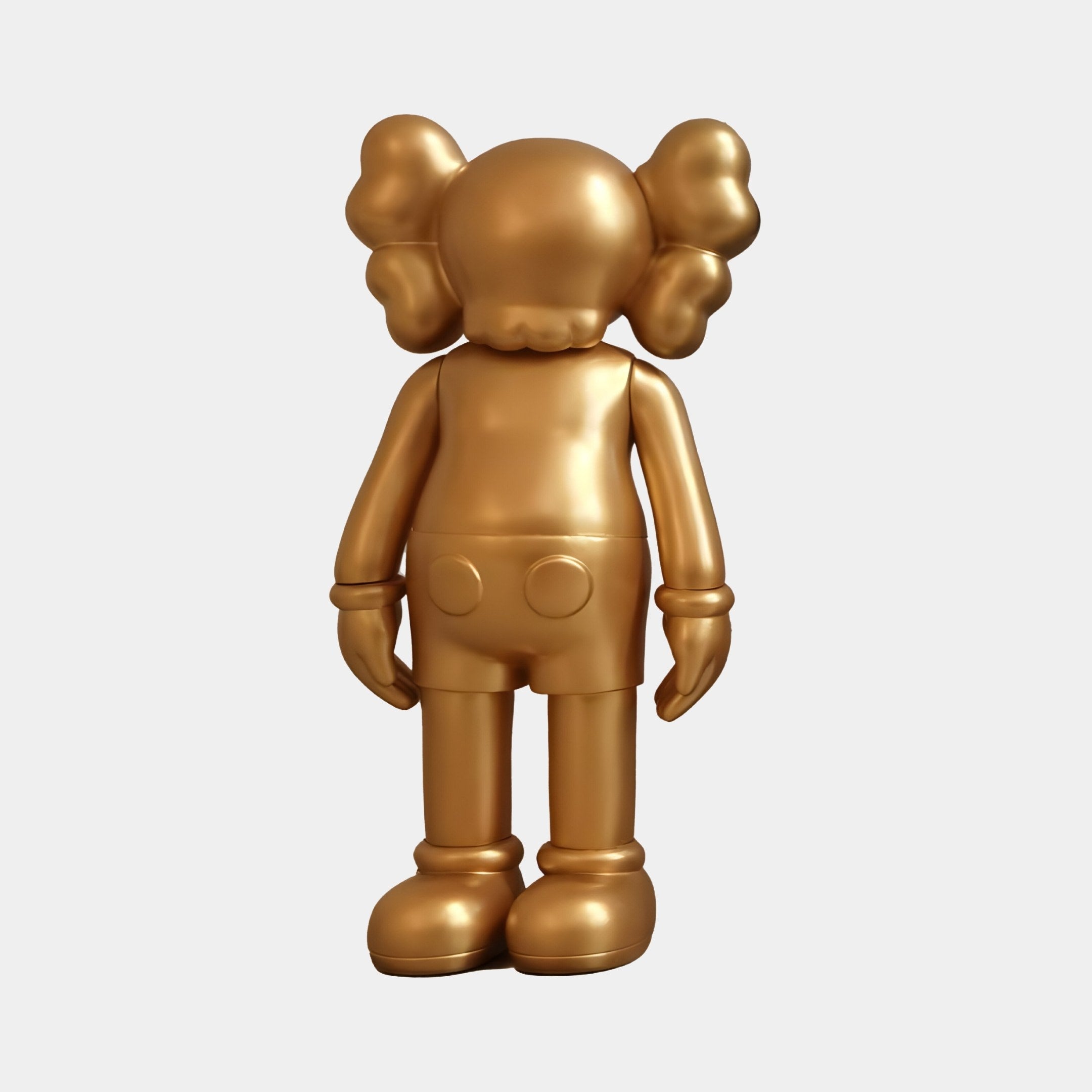 The Champagne Satin Gold Iconify Standing Figure by Giant Sculptures is a 20cm golden sculpture with round ears and gloved hands. Its smooth, minimalist design and shiny metallic finish make it a modern, elegant décor addition to any space.