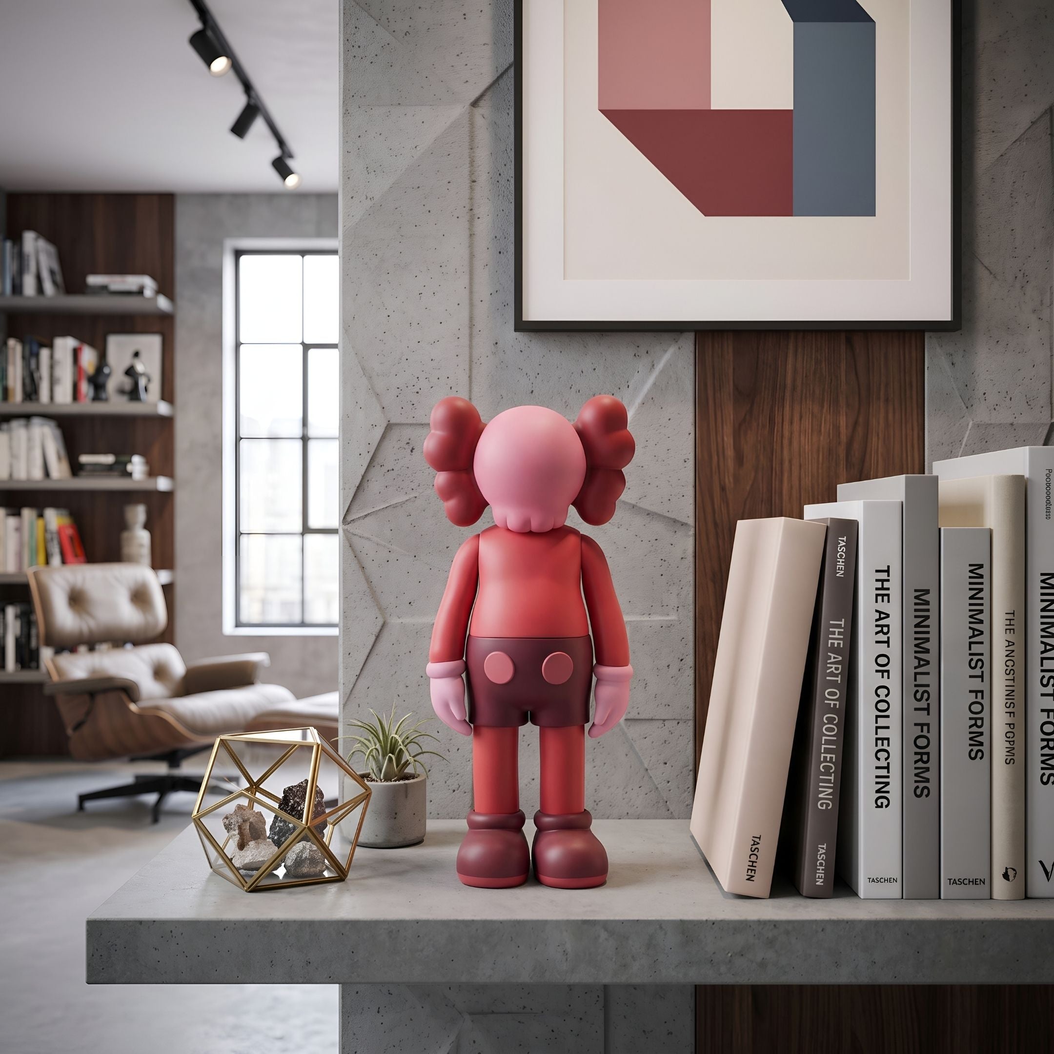 Blush Ruby Iconify Standing Figure, 20cm polyvinyl collectible in pink and ruby-red, displayed on a concrete shelf beside books in a modern living room.