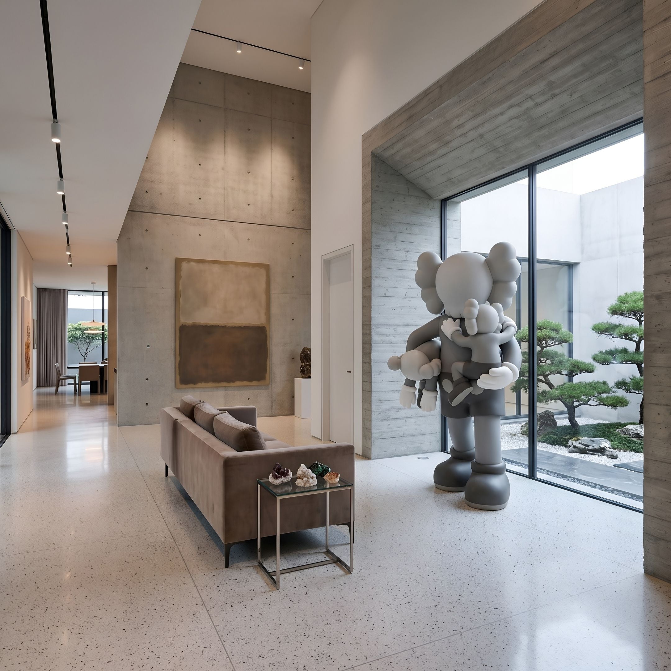 Soft Grey Iconify Family Sculpture, 200cm, in a modern lounge with sofa and abstract wall art, grey resin figure holding two smaller figures near a glass wall.