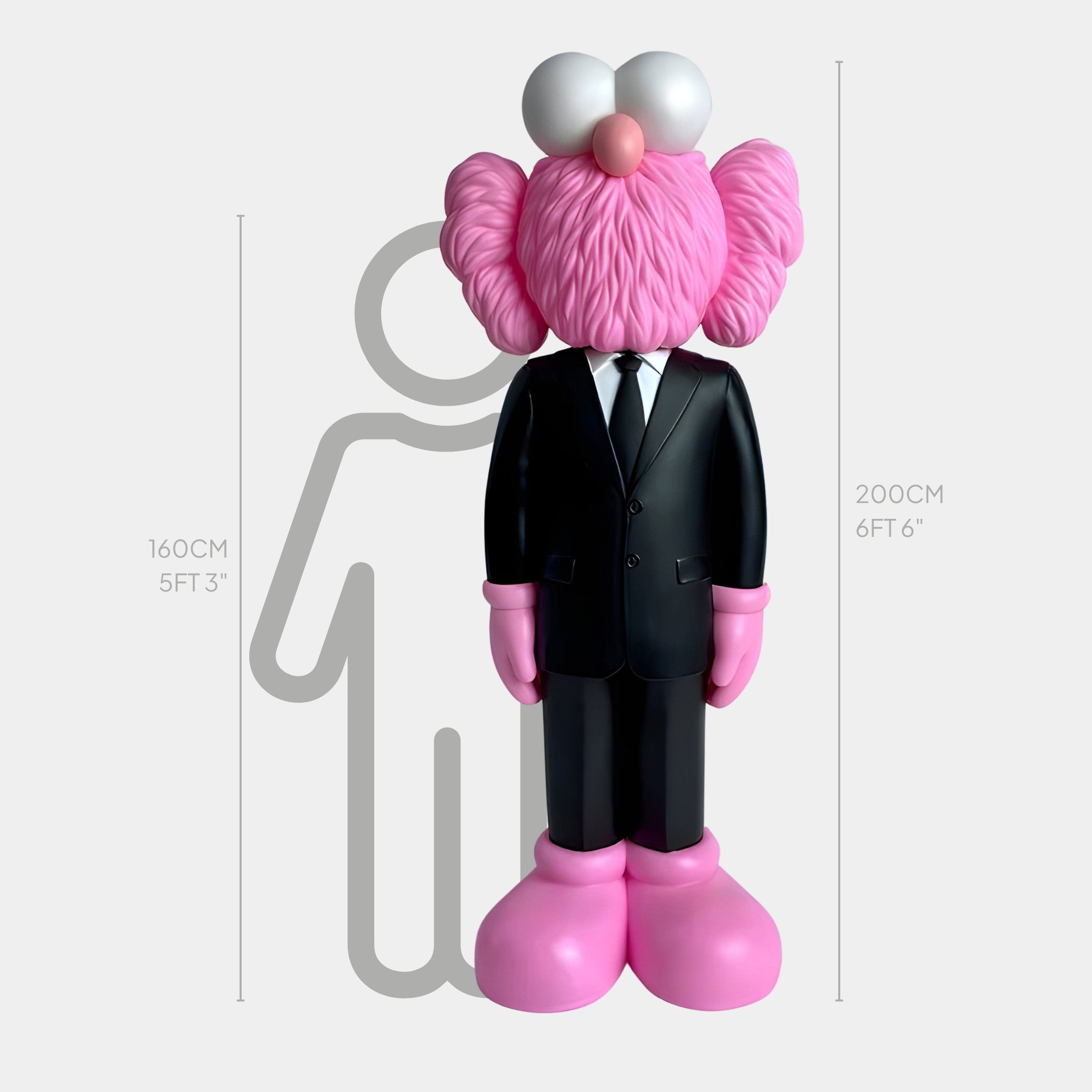 The Black Suit Iconify CEO Sculpture from Giant Sculptures embodies the Contemporary Artistic Vision at 200 cm in a sleek black suit and pink boots. A 160 cm silhouette for scale highlights its big eyes and fluffy ears, reflecting a pink fuzzy character’s charm.