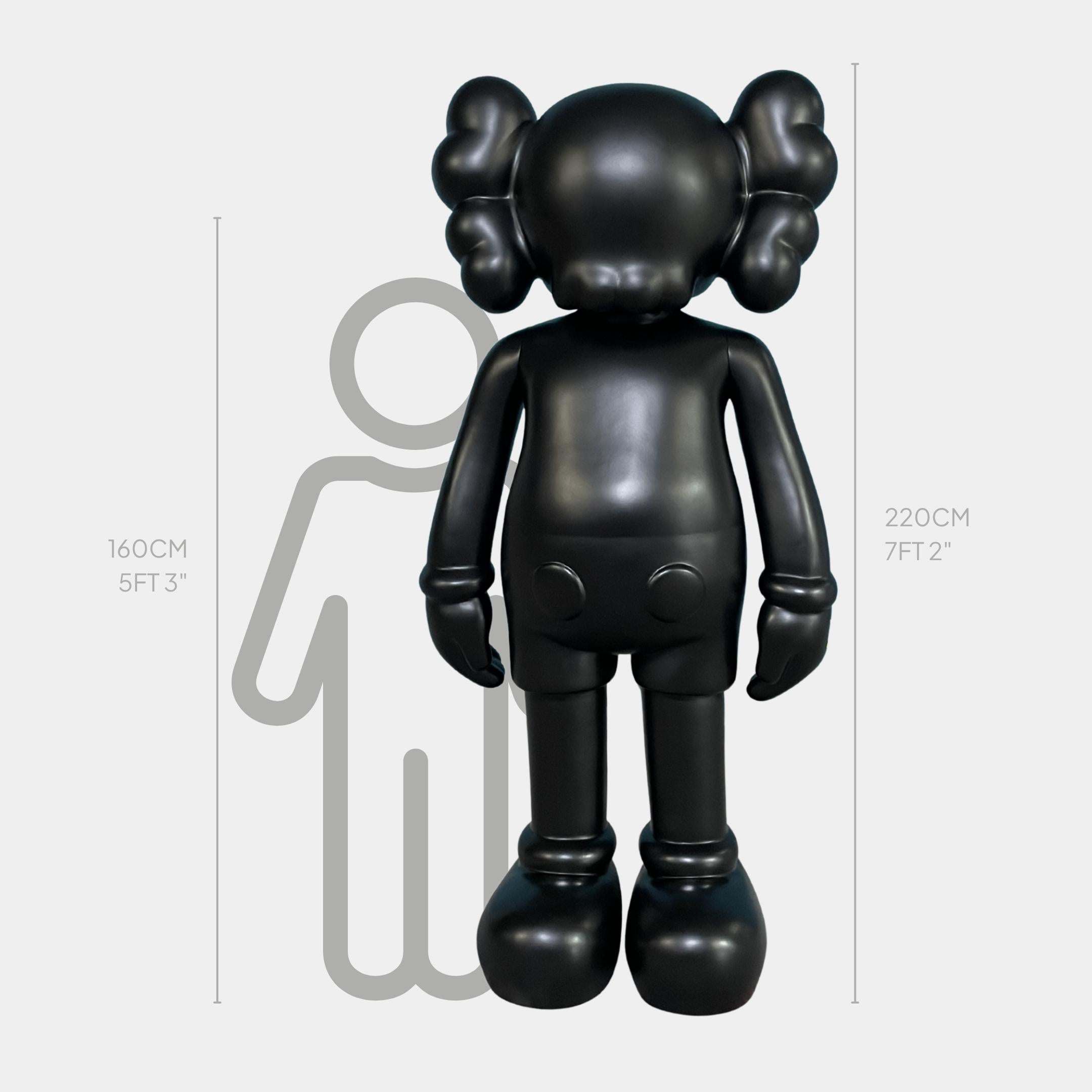 Midnight Black Iconify Standing Sculpture by Giant Sculptures, 220cm front view in glossy black resin beside a human silhouette scale on grey background.