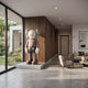 Hazelnut Brown Iconify Standing Sculpture, 220cm, on a stone platform against a walnut wall in a modern living room with a beige armchair and sofa.
